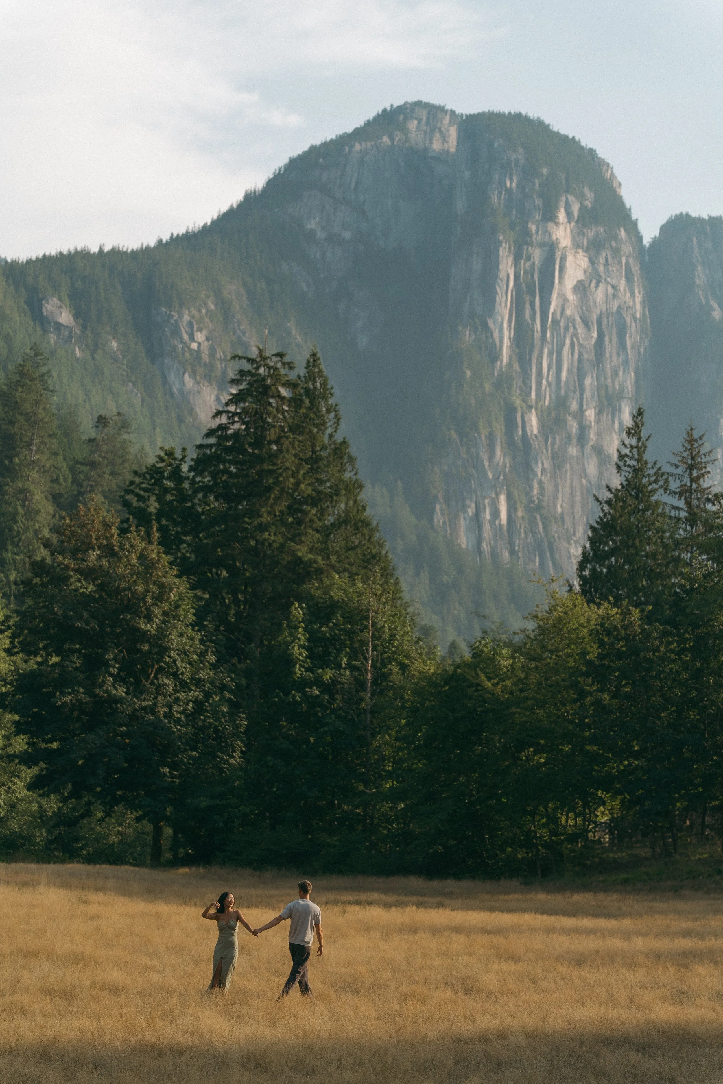 couples golden hour engagement session in the mountains and a field in Squamish BC