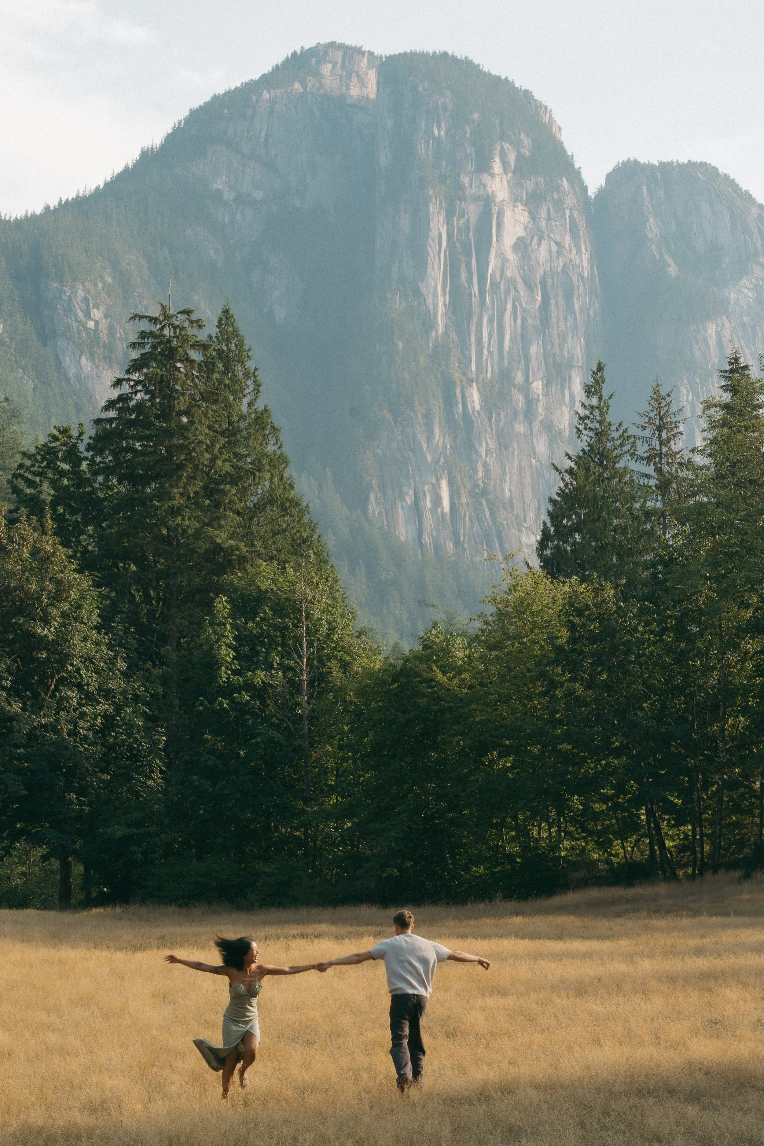 couples golden hour engagement session in the mountains and a field in Squamish BC