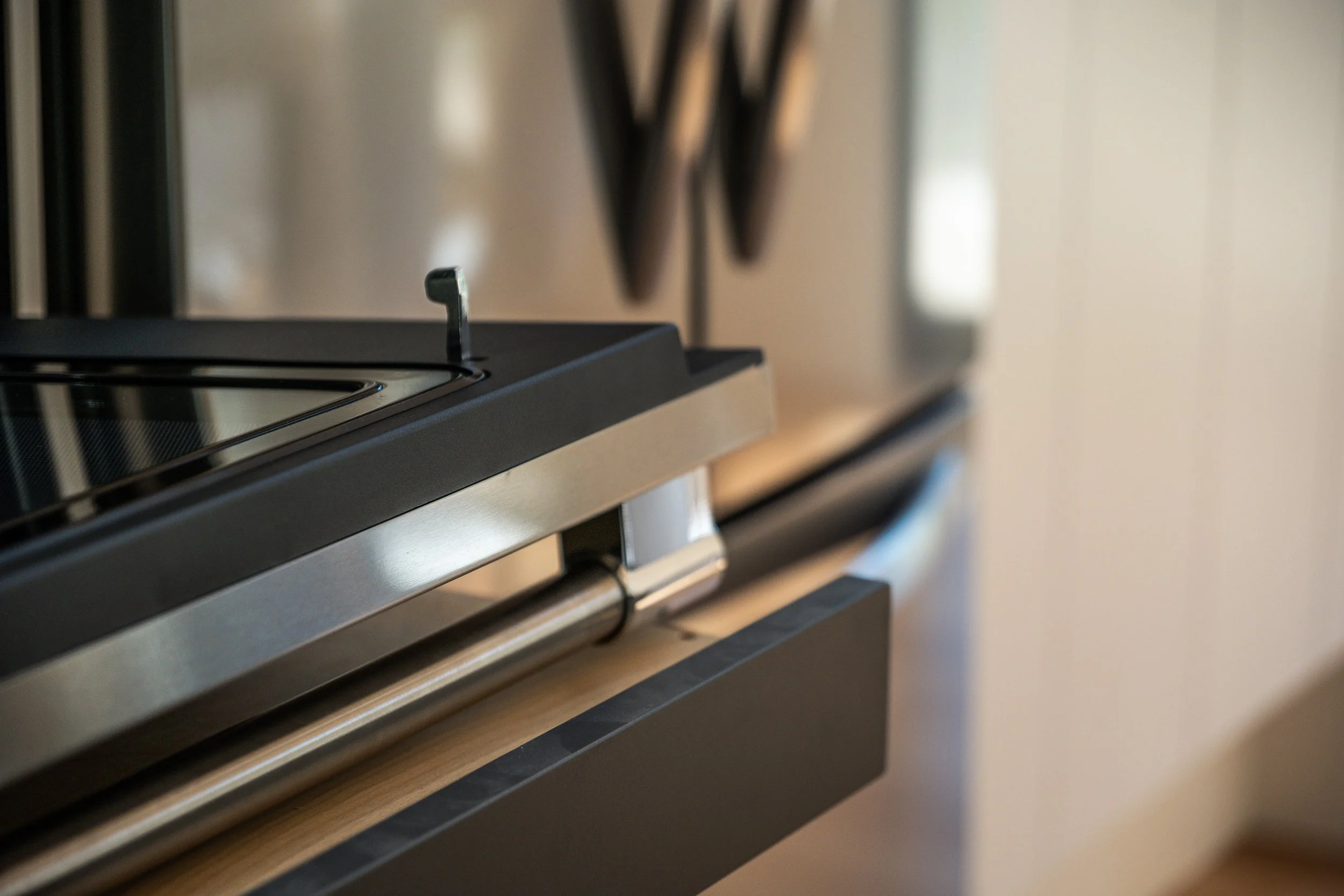 Close-up of a modern stove with metal and black features in a kitchen setting.