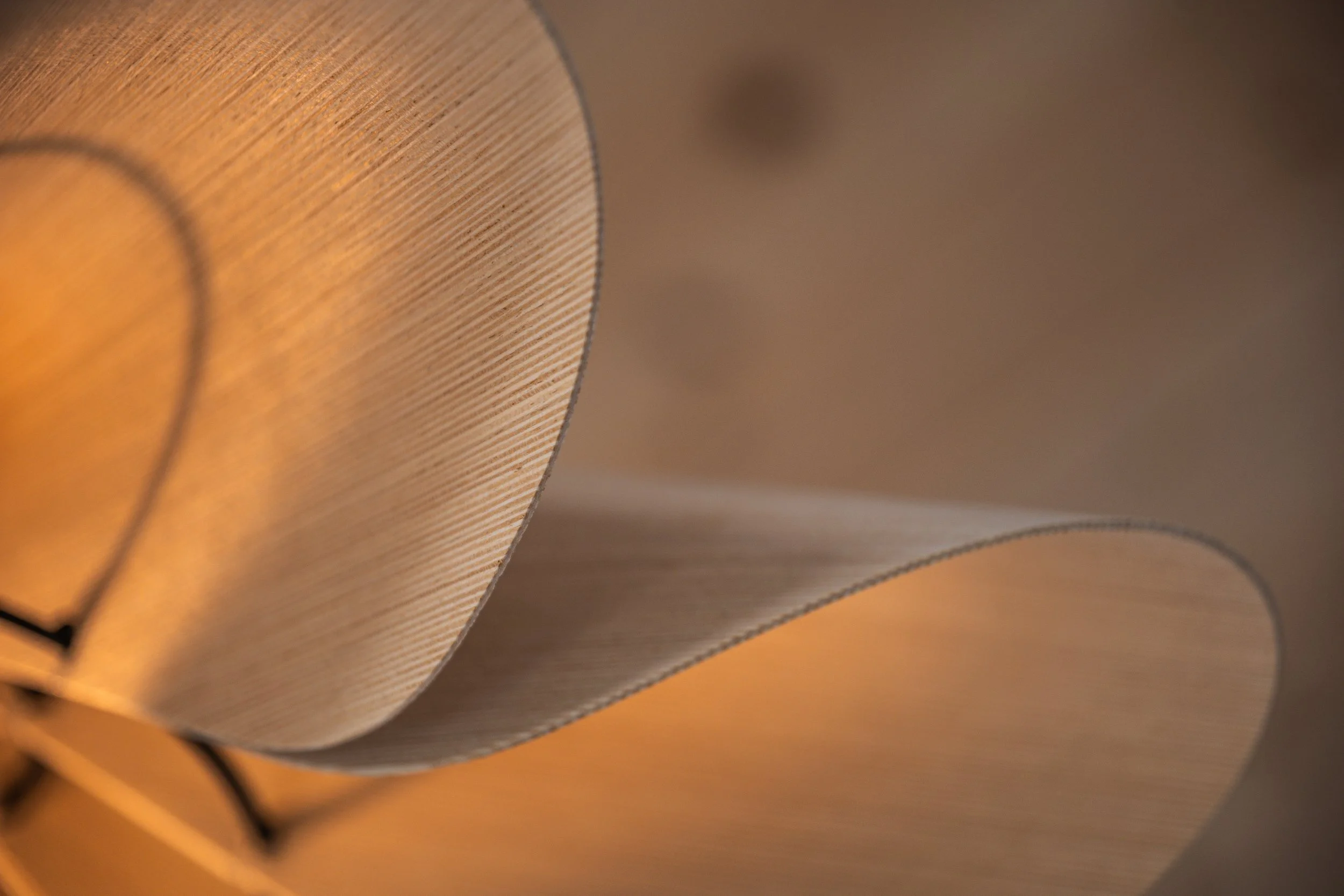 Close-up of a paper lantern with a warm glow, showing the texture and folds of the paper.