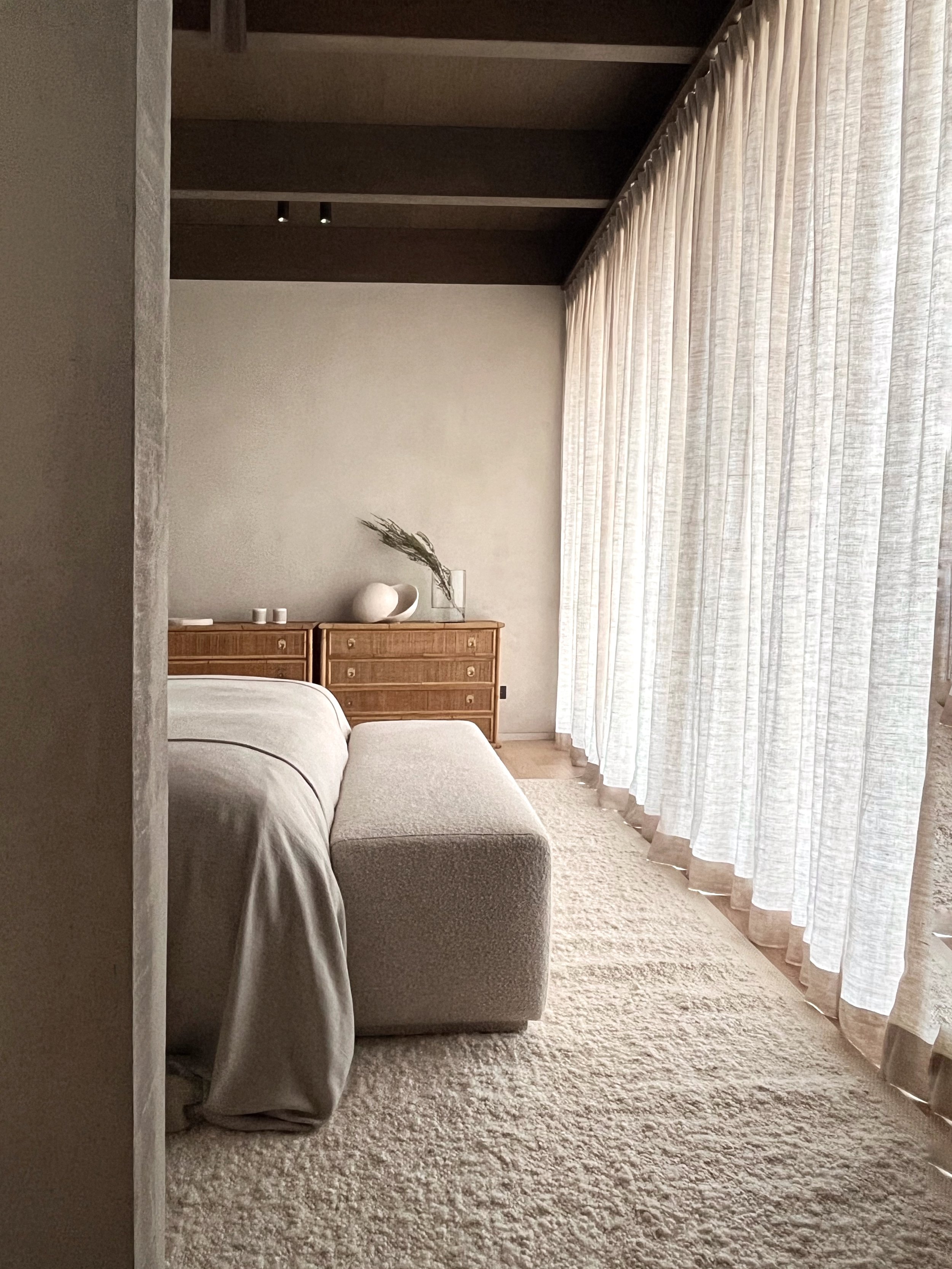 beautiful and timeless comporta style summer house master suite interior design vintage rattan chest of drawers wool handmade Coral & Hive rug linen curtains