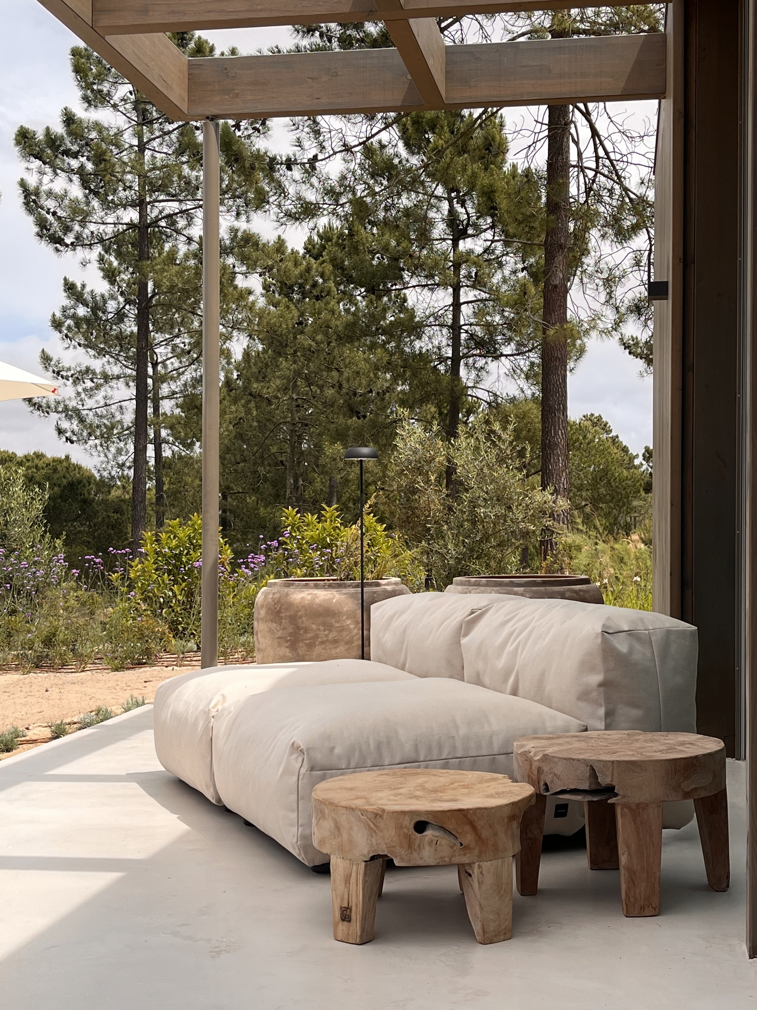 outddor lounge area comporta style summer house interior design vetsak sofa gommaire tables