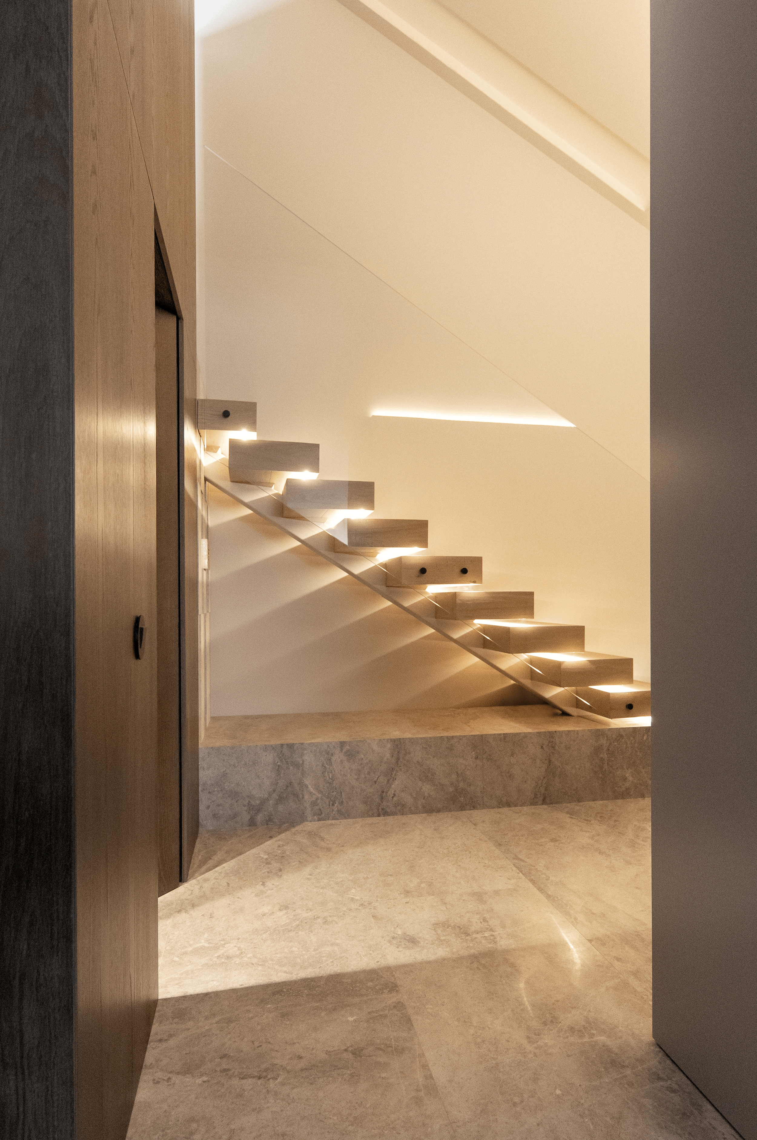 modern contemporary suspended steps staircase design with LED lighting elegant and timeless interior design duplex apartment