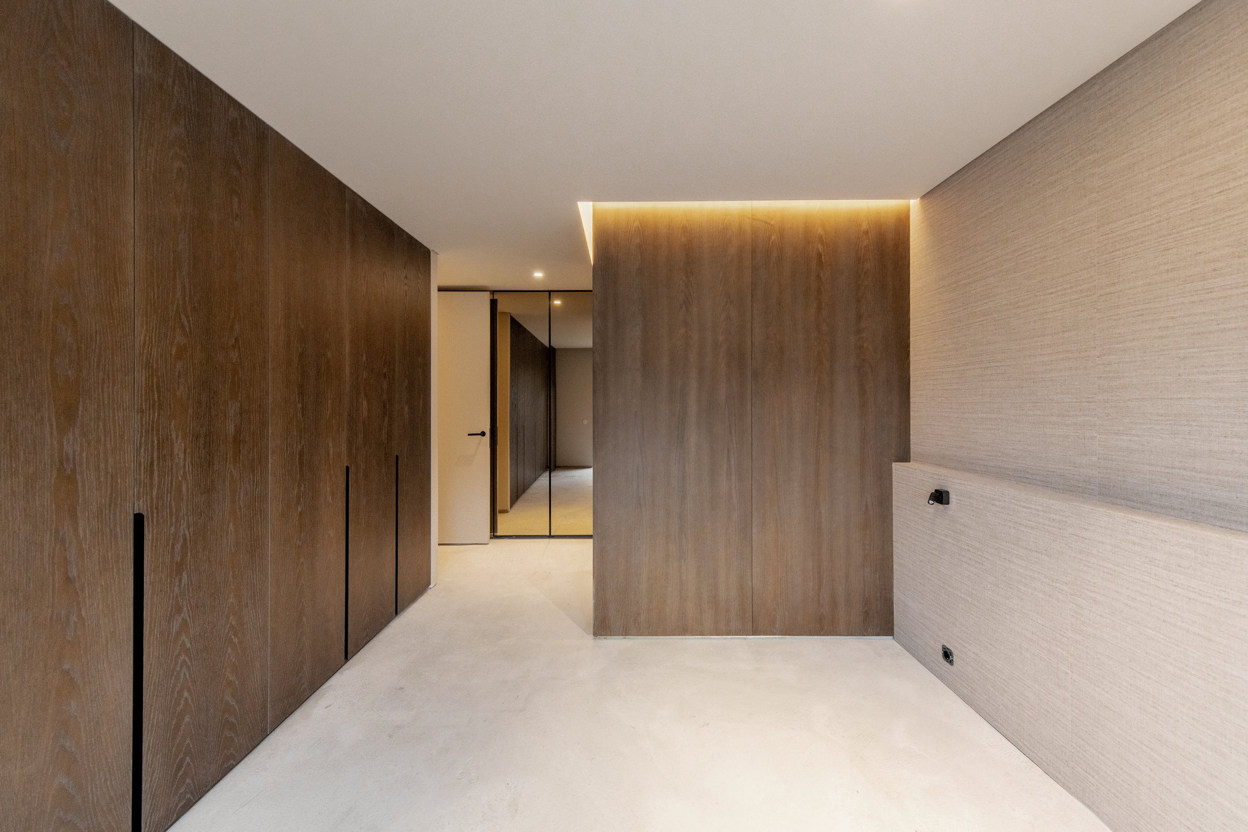 elegant timeless luxury master suite interior design dark walnut wood linen wallpaper and silk carpet
