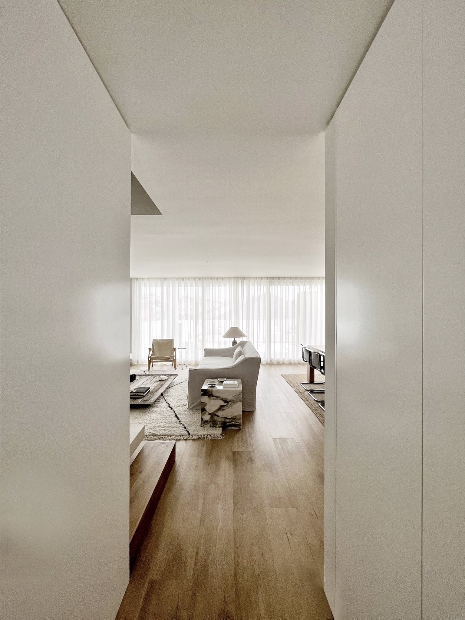 contemporary minimalist living room interior design with belgian linen sofa Carl Hansen armchair berber rug minimal with soul