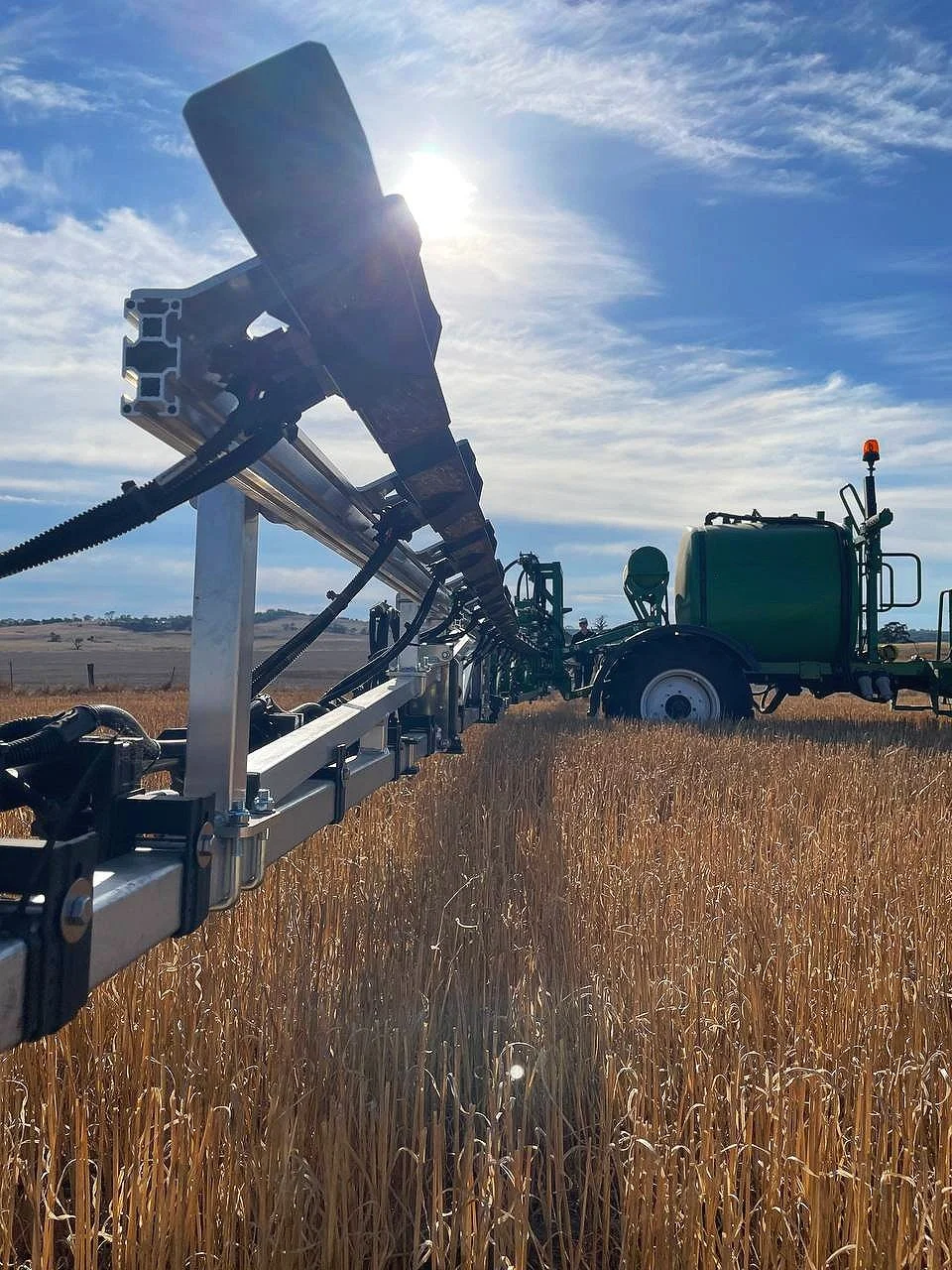 Agricultural sprayer in a wheat field
