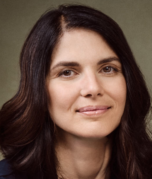 Smiling person in a suit outdoors