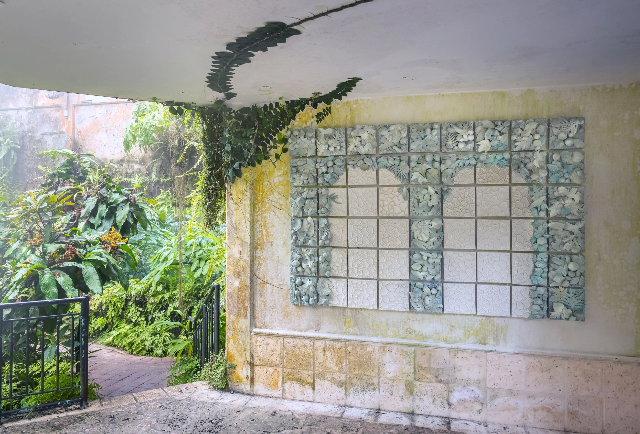 Site-specific ceramic wall sculpture at Fairchild Tropical Botanic Garden composed of modular tiles cast from native and exotic flora, created through public workshops to promote environmental stewardship and celebrate South Florida’s biodiversity.