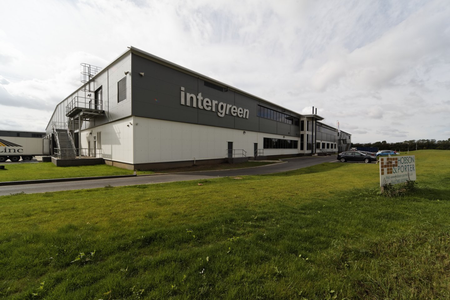 Industrial building with "intergreen" signage, surrounded by grassy lawn, with a sign for Hobson & Porter in the foreground.