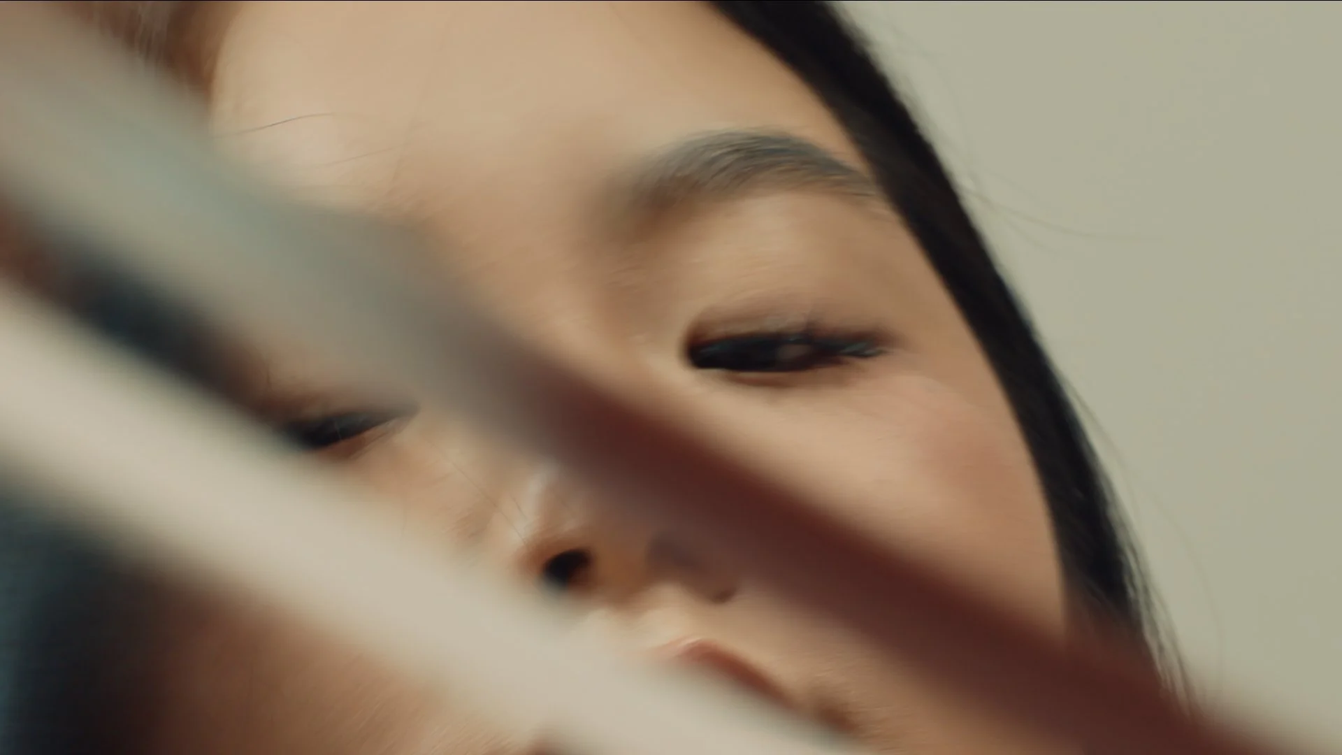 Close up of the face of a girl playing the cello.