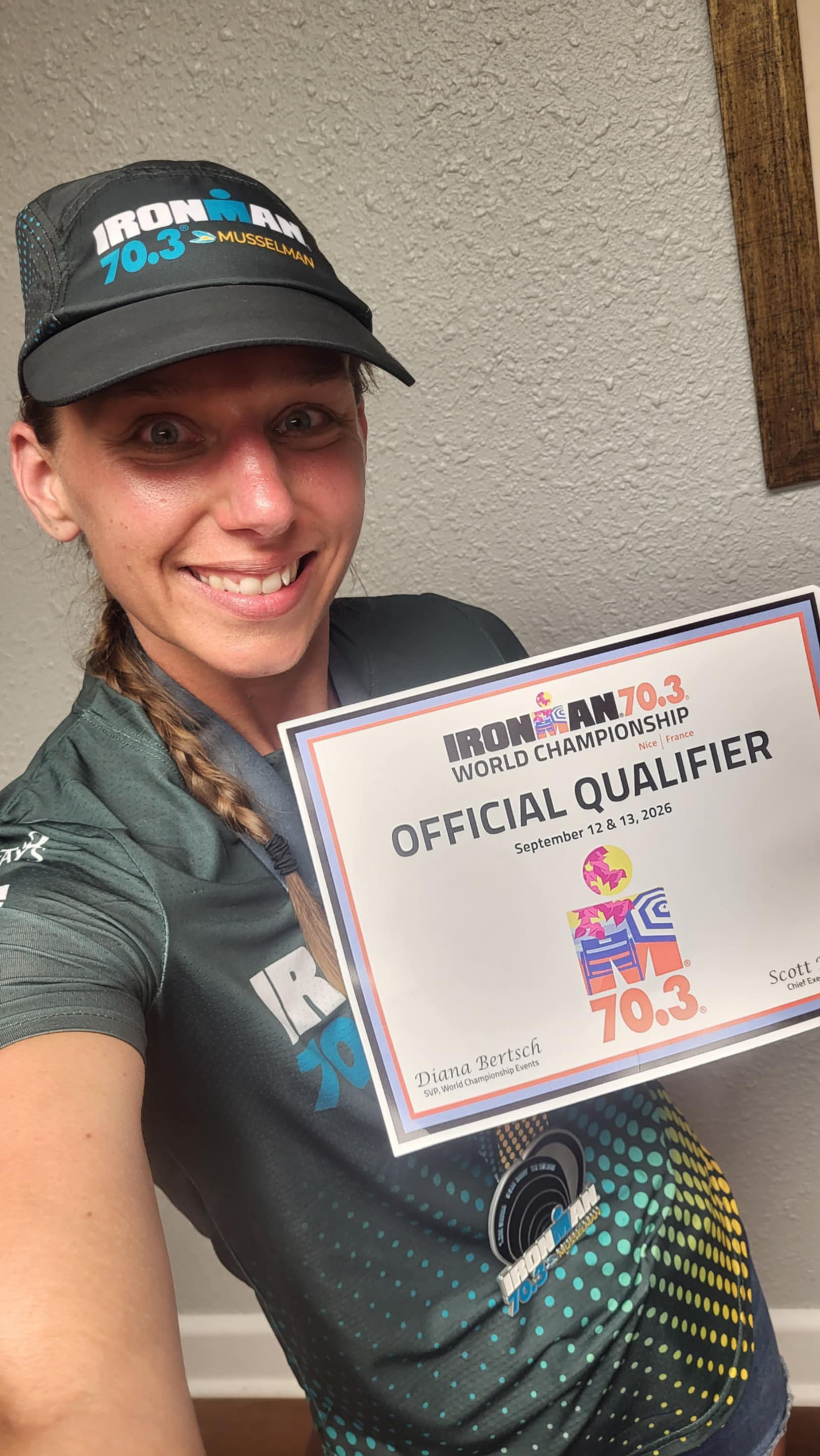 Coach Michelle Carr holding her Ironman 70.3 World Championship qualifier certificate