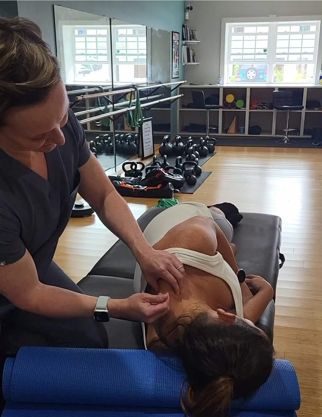 an athlete receiving acupuncture by Angela of North Country Acupuncture demonstrates during a Wellness workshop.
