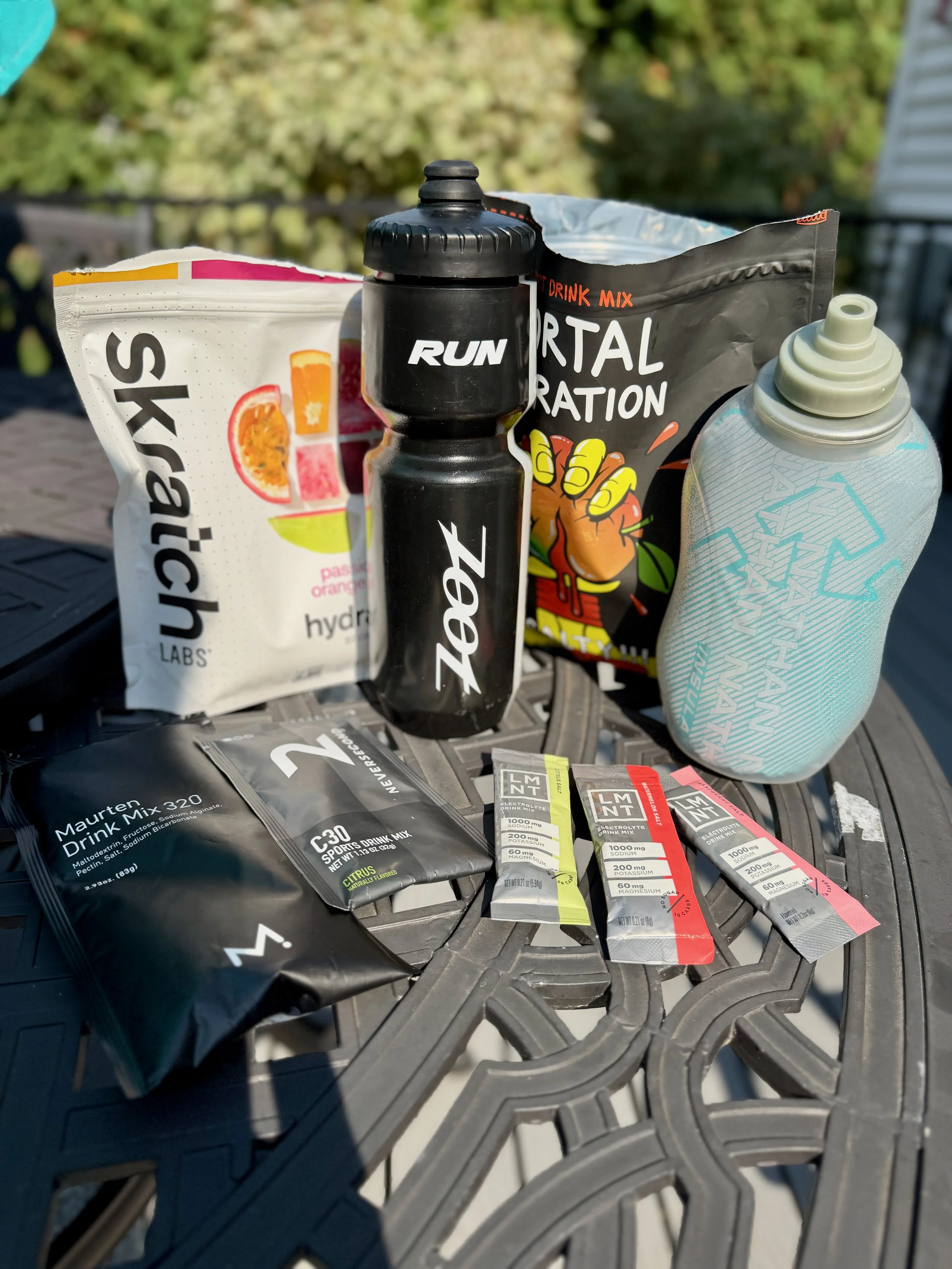 Hydration products including Skratch, Mortal Hydration, and LMNT used by runners to replace fluids, carbohydrates, and electrolytes during long runs.