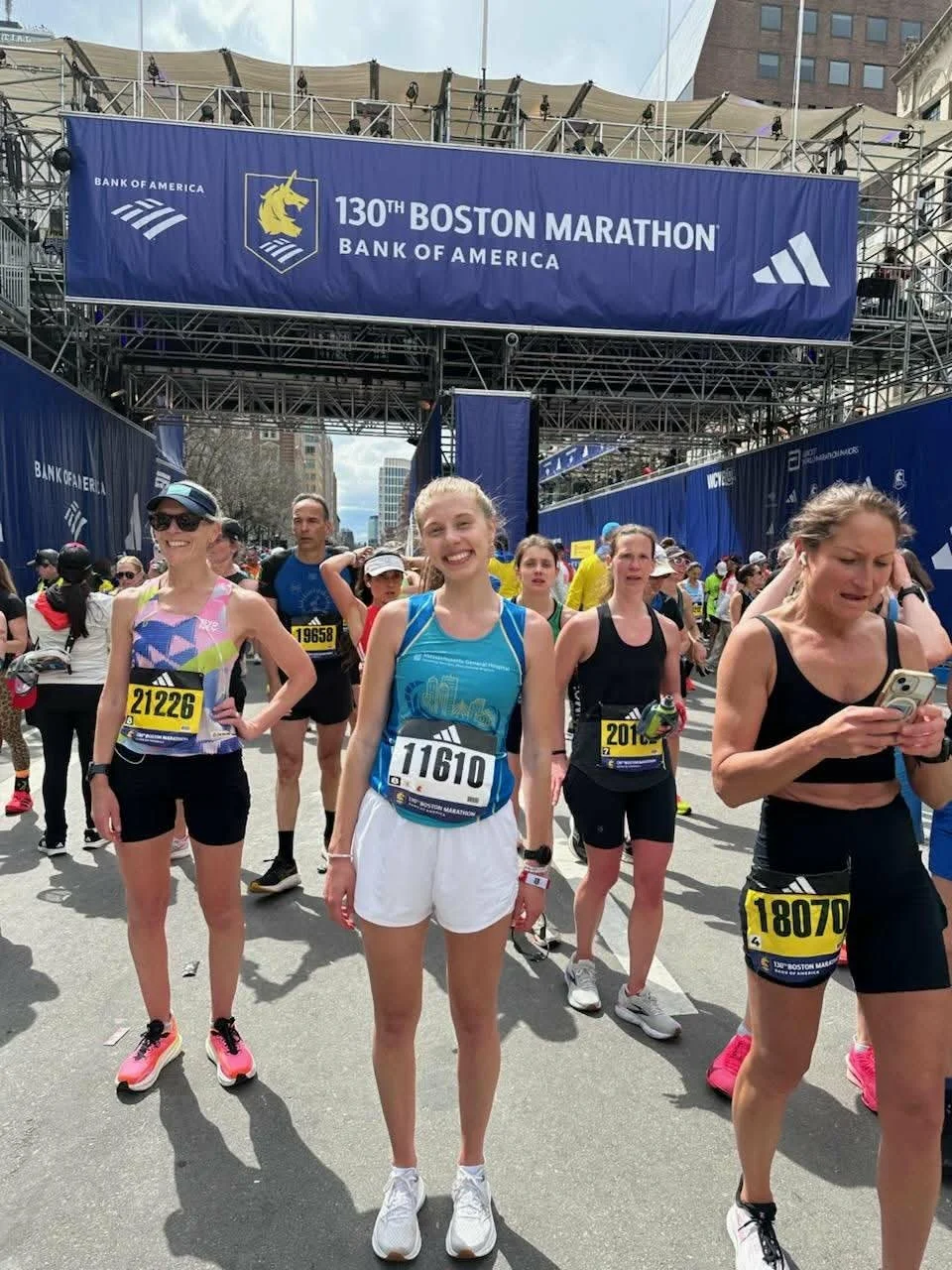 Runner smiling at the start of the Boston marathon.