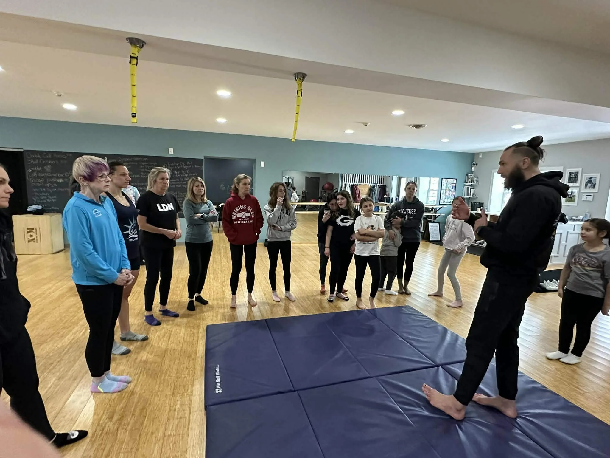 Master Kyle Phillips demonstrating martial arts techniques to a group of women and children at Keep Fit in Guilderland, NY.