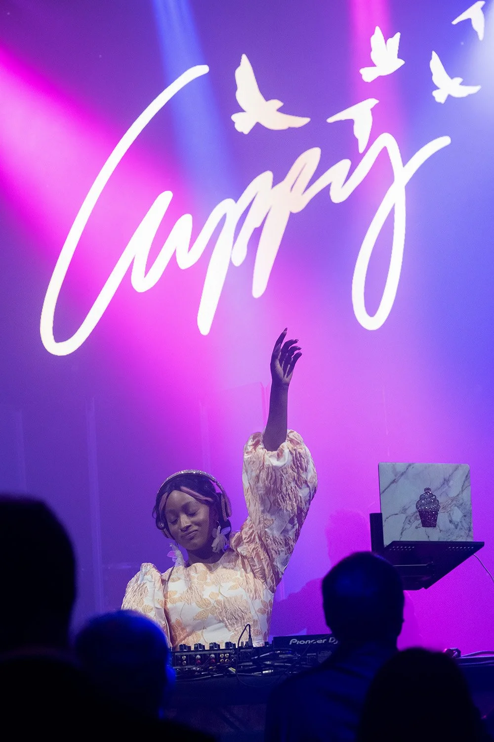 Photos that show the energy and spirit of the event as in this image of DJ Cuppy entertaining the crowd.