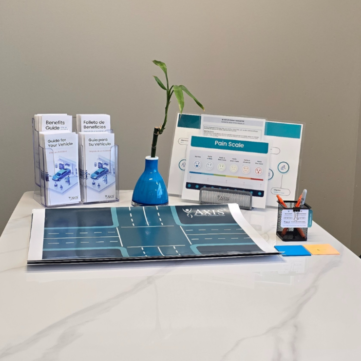 Consultation desk with helpful car accident recovery resources at Axis Chiropractic and Massage West Valley City Utah