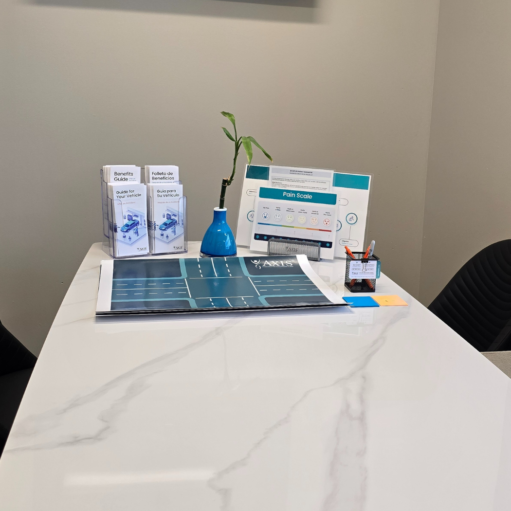 Consultation desk with helpful car accident recovery resources at Axis Chiropractic and Massage West Valley City Utah