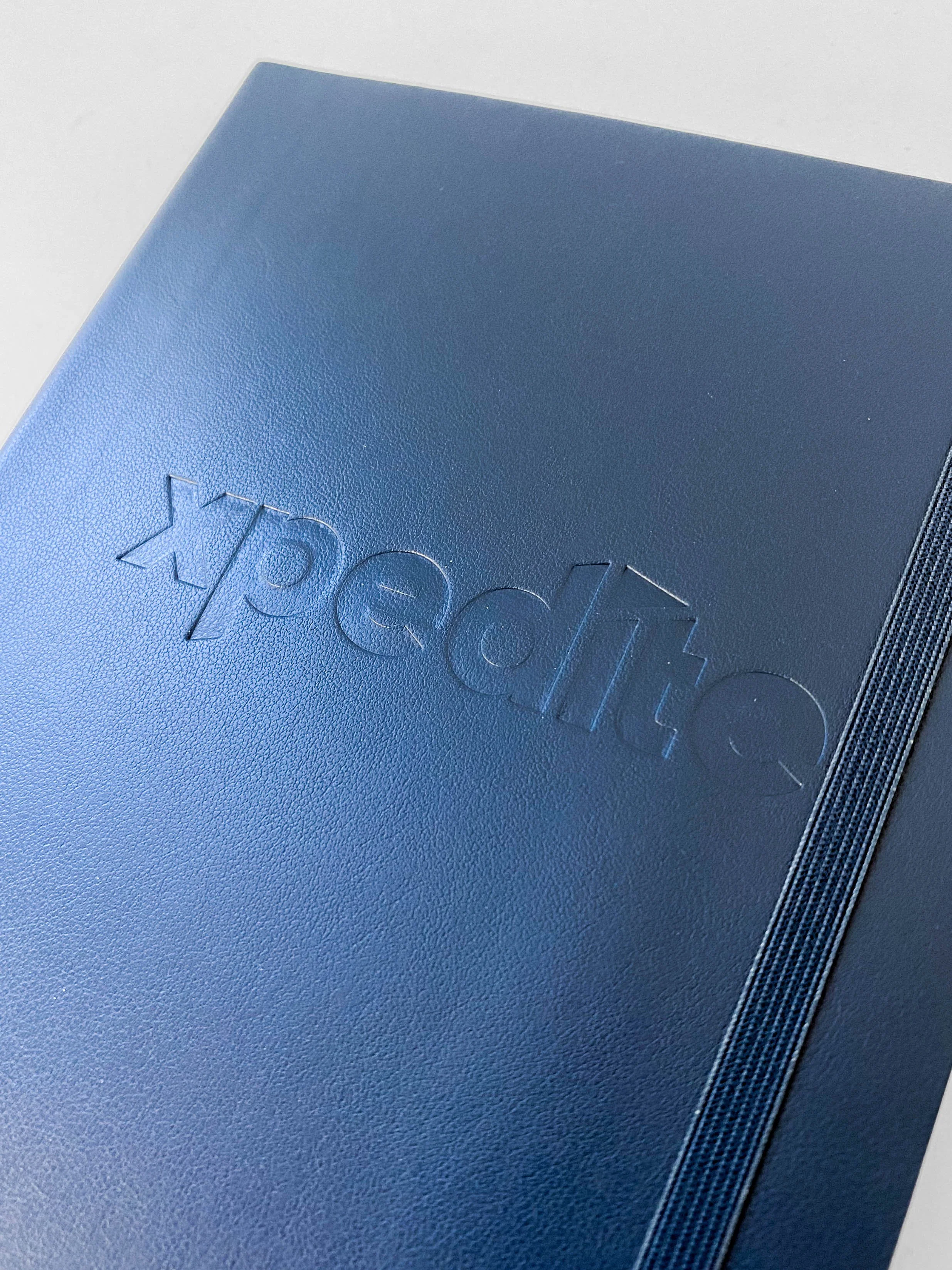 Navy notebook with debossed logo