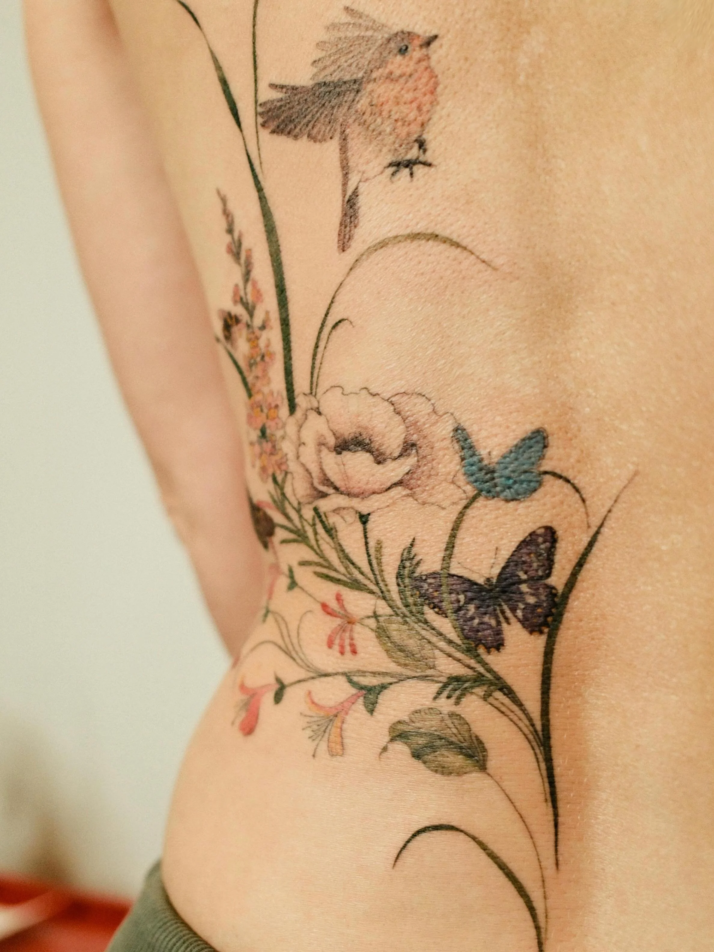 A lovely colourful floral arrangement to balance my client's existing back tattoo (made by another tattoo artist). 🌸

Each flower and animal is a representation of her family and loved ones, which makes this artwork not only an aesthetically pleasin