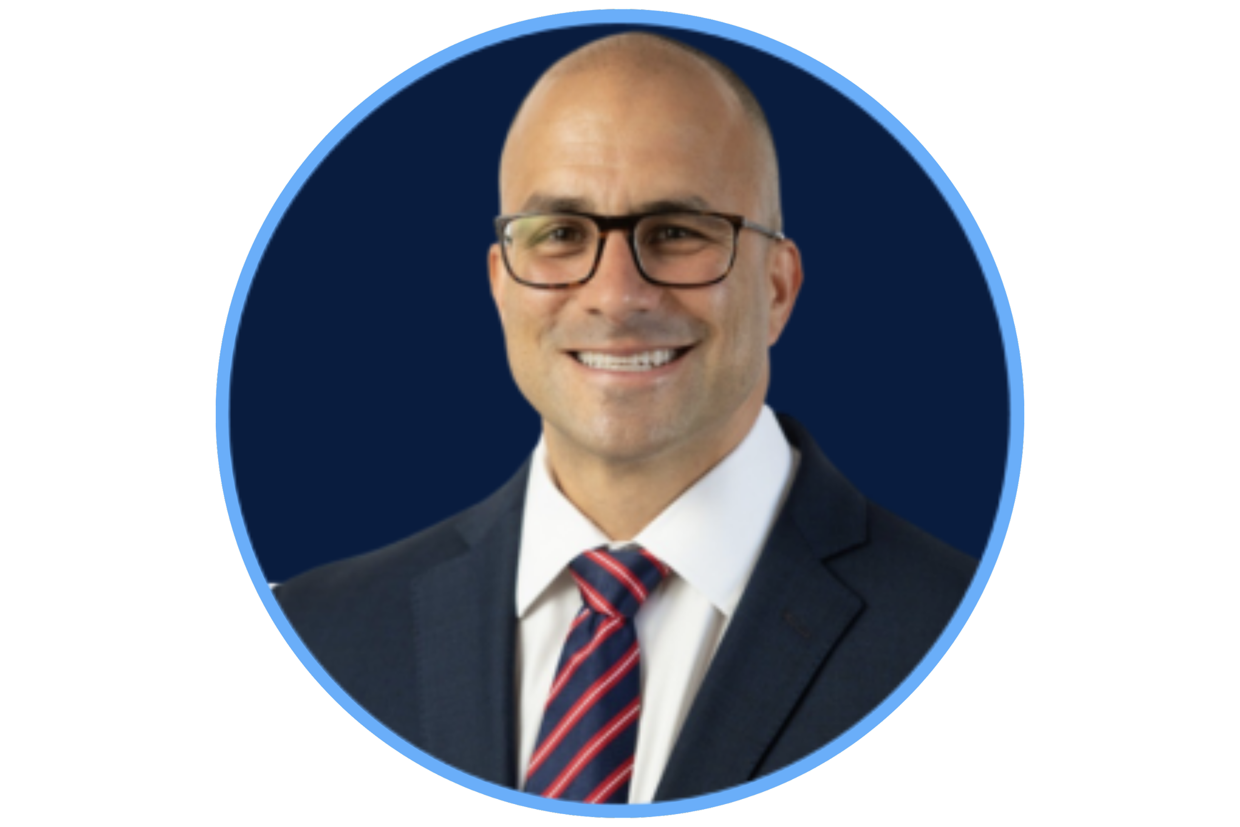 Headshot of a man with glasses, bald head, wearing a suit, white shirt, striped tie, smiling, against a dark blue background.