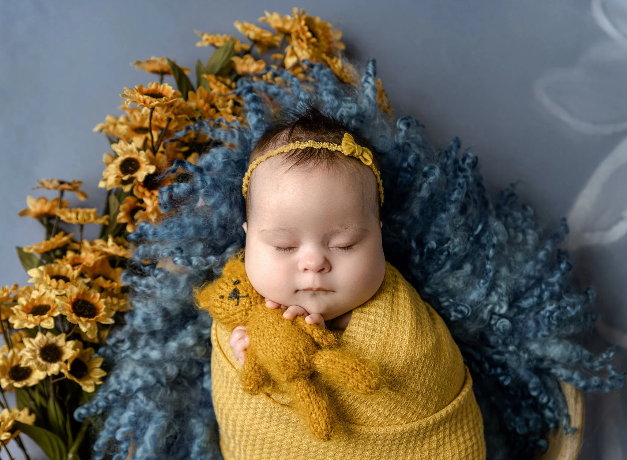 Here is a sneak peak from yesterday's newborn session. This precious little girl was a rock star for her session and we were able to get through a bunch of setups.  This blue/yellow one was something special and I love how it turned out, don't you?

