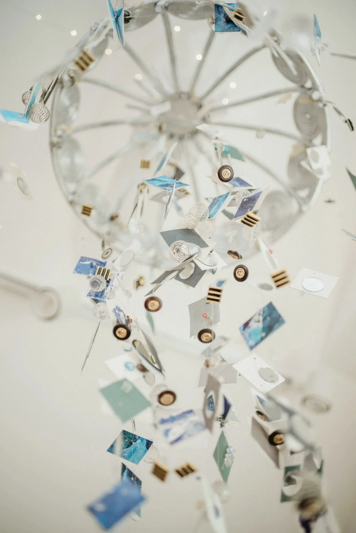 Colorful hanging art installation with prisms and mirrors