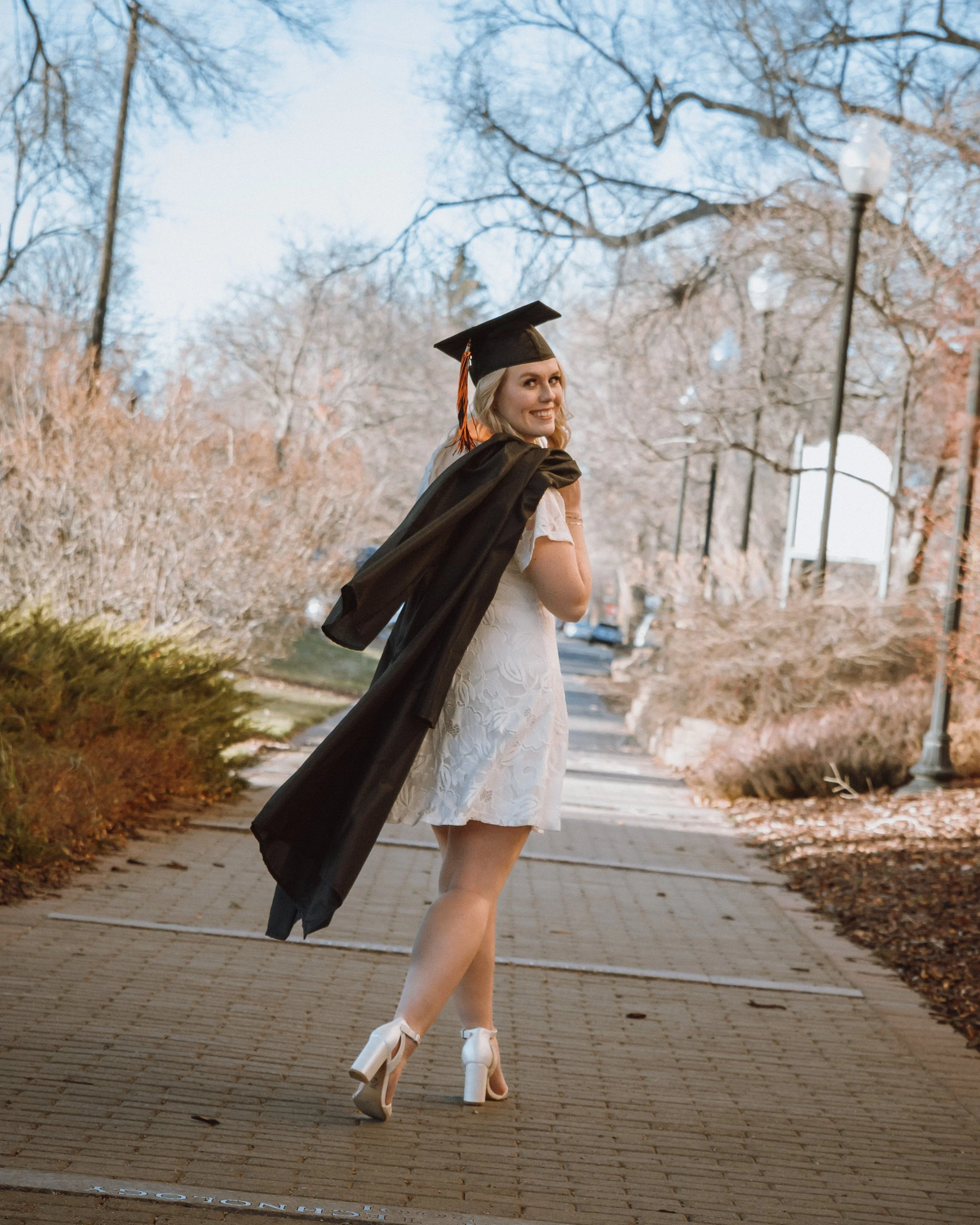 women on campus at idaho state university getting her graduation photos done
