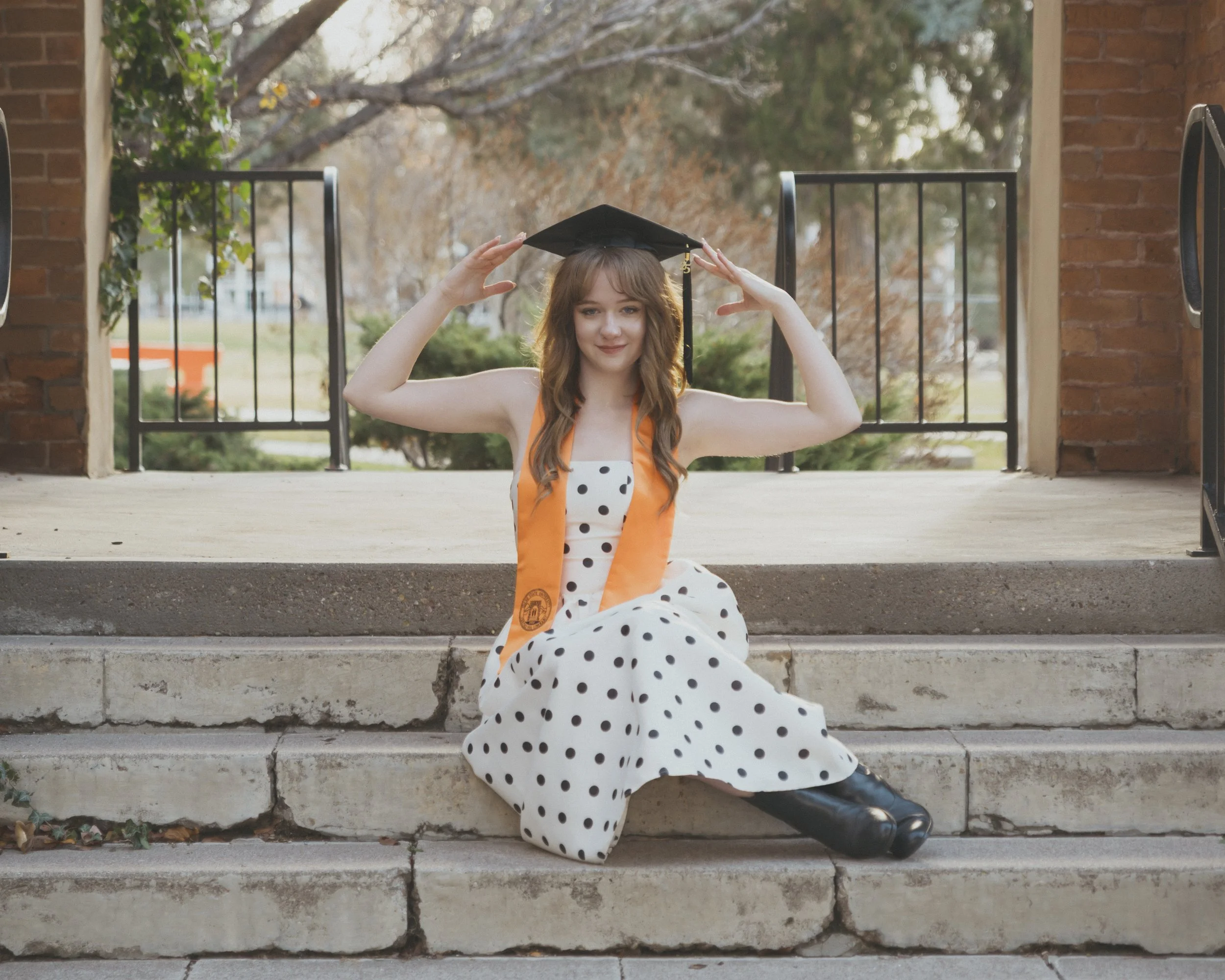 women sitting on the steps in pocatello at idaho state university graduating