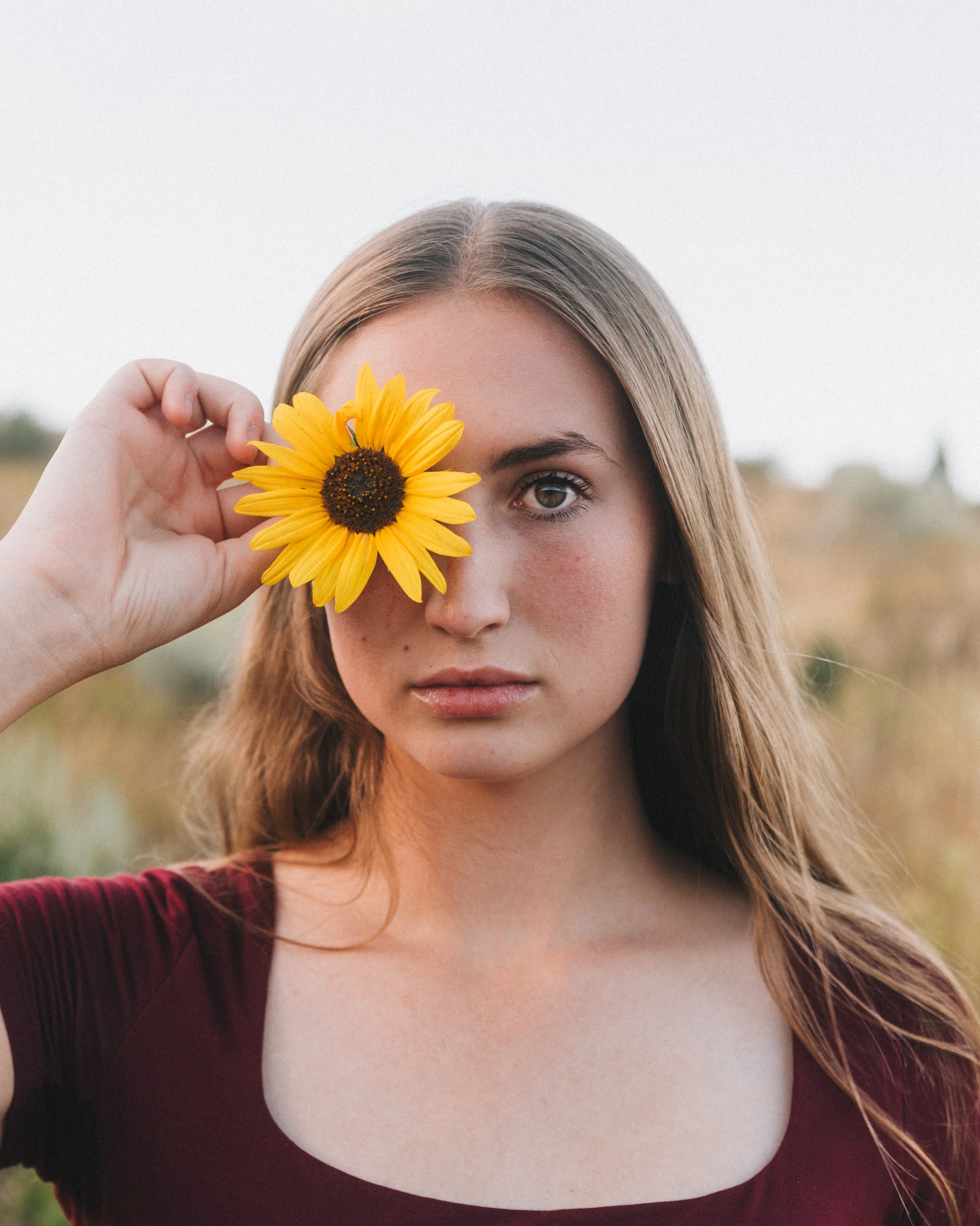 model getting her photo taken in pocatello idaho with sunflowers and wild flowers