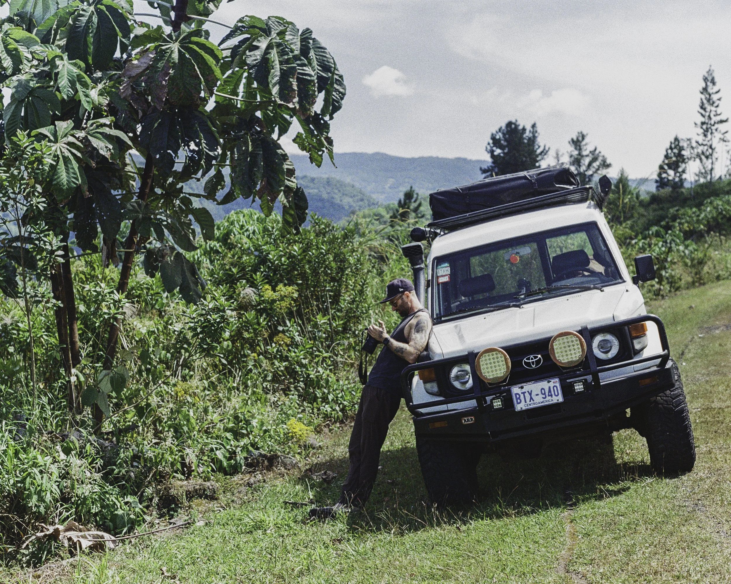 documentary photographer reviewing photos on assignment in Central America