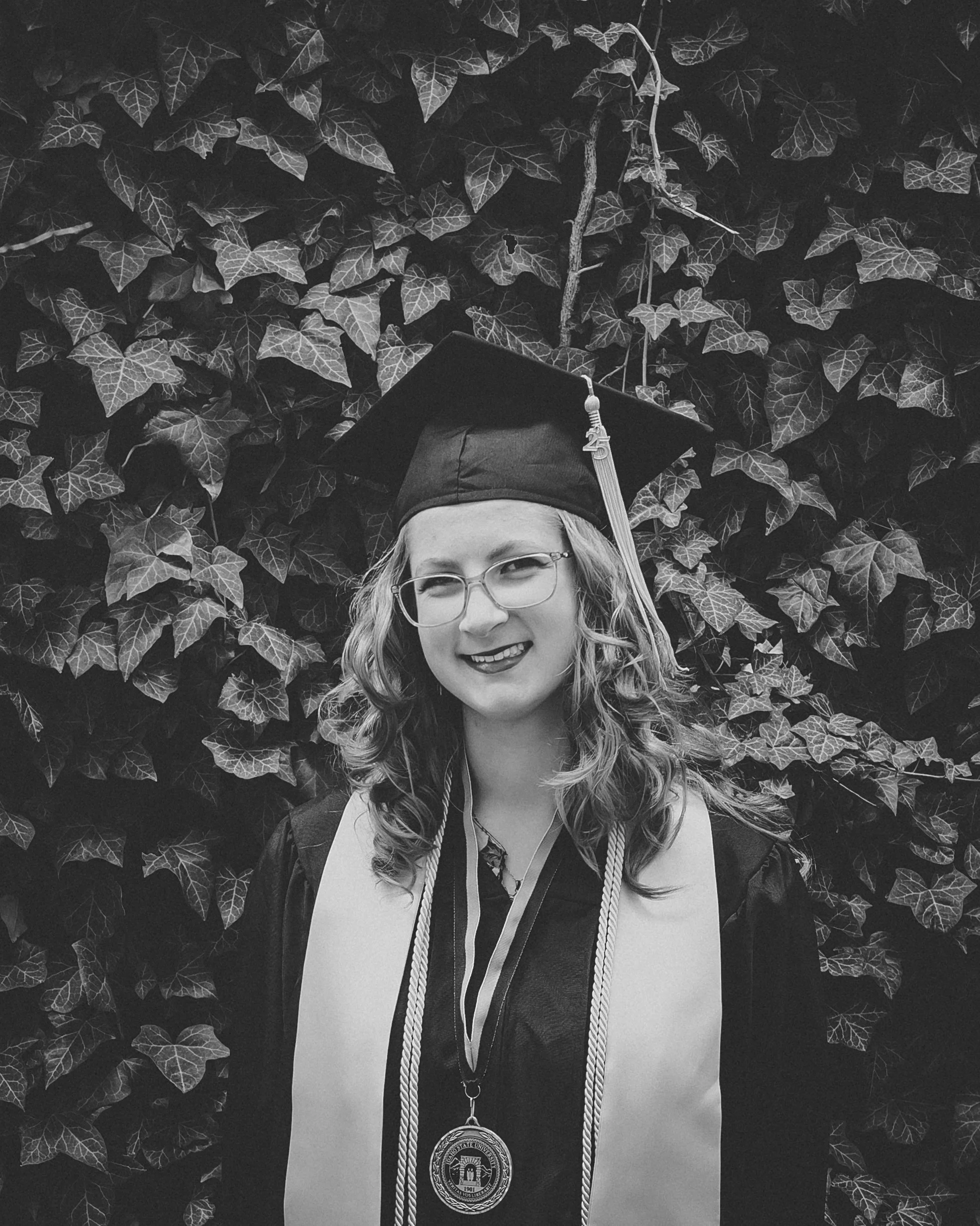 black and white photo of a women graduating at isu on campus for her graduation photoshoot