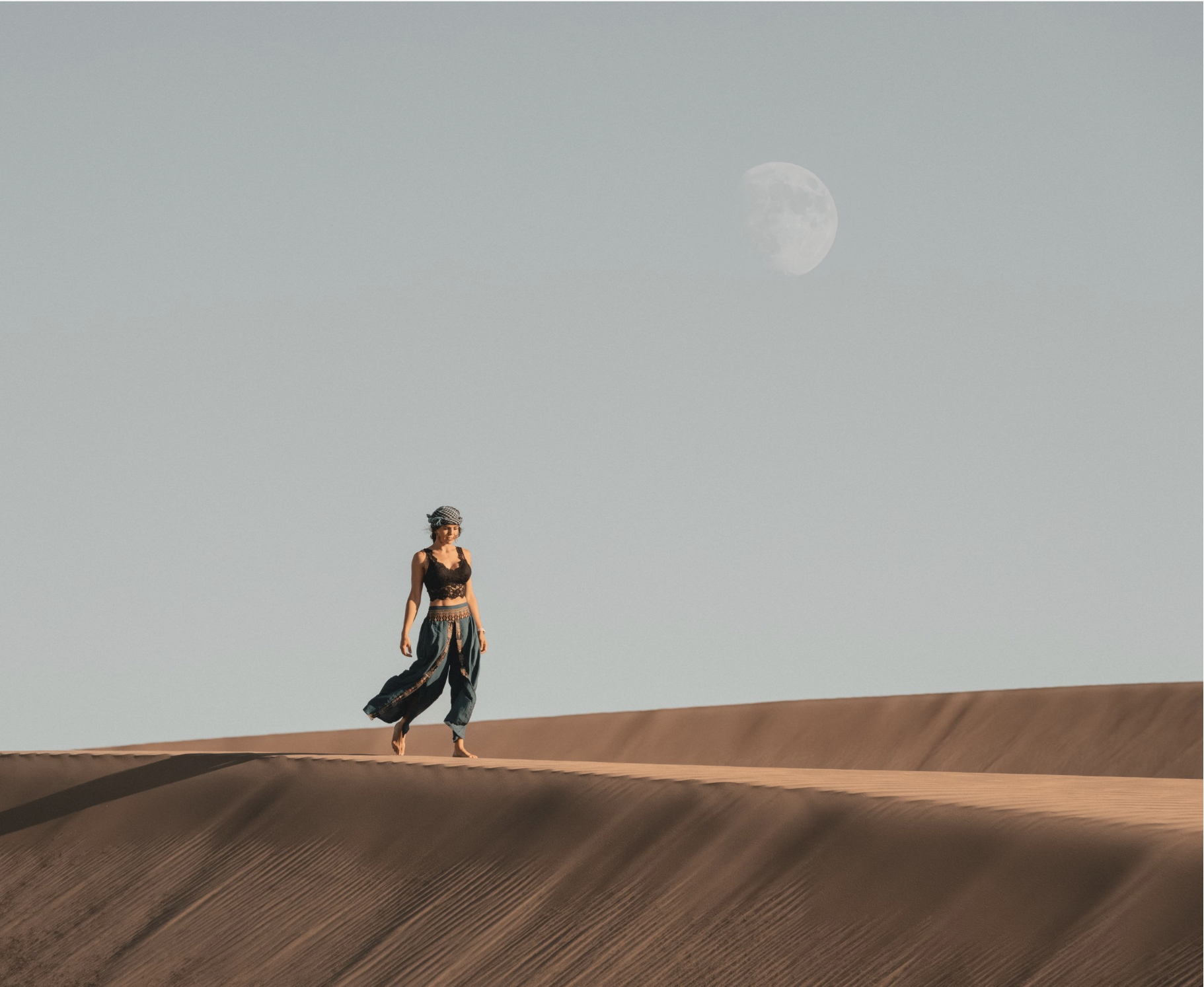 women walking through the desert in a documentary style photo