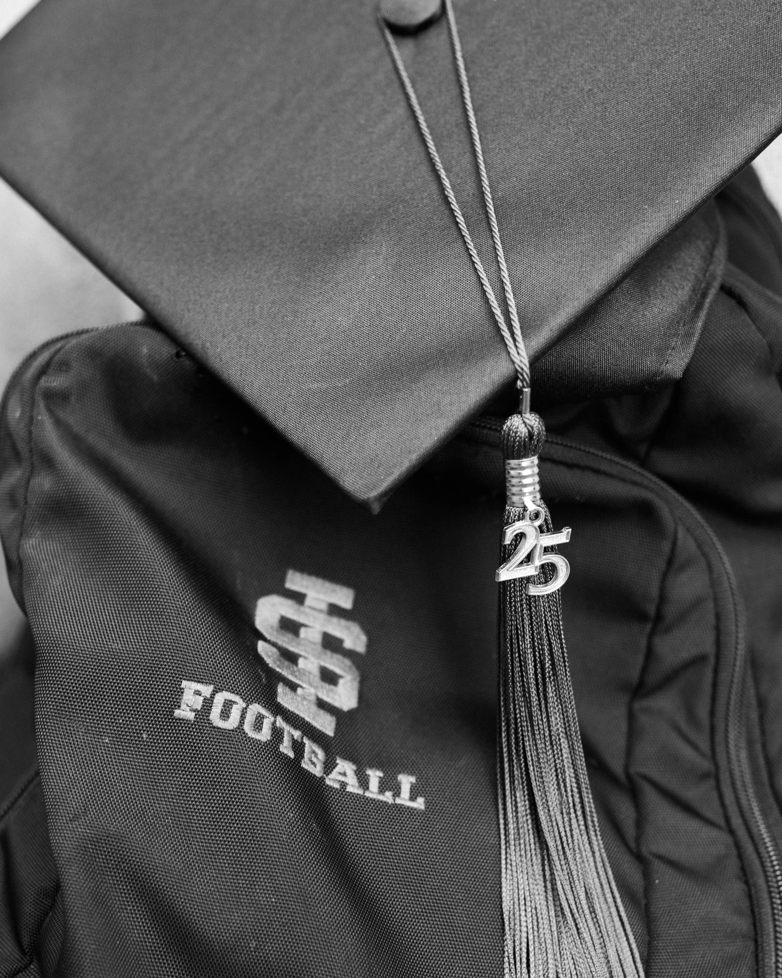 idaho state university football graduation photo with cap and gown back and white