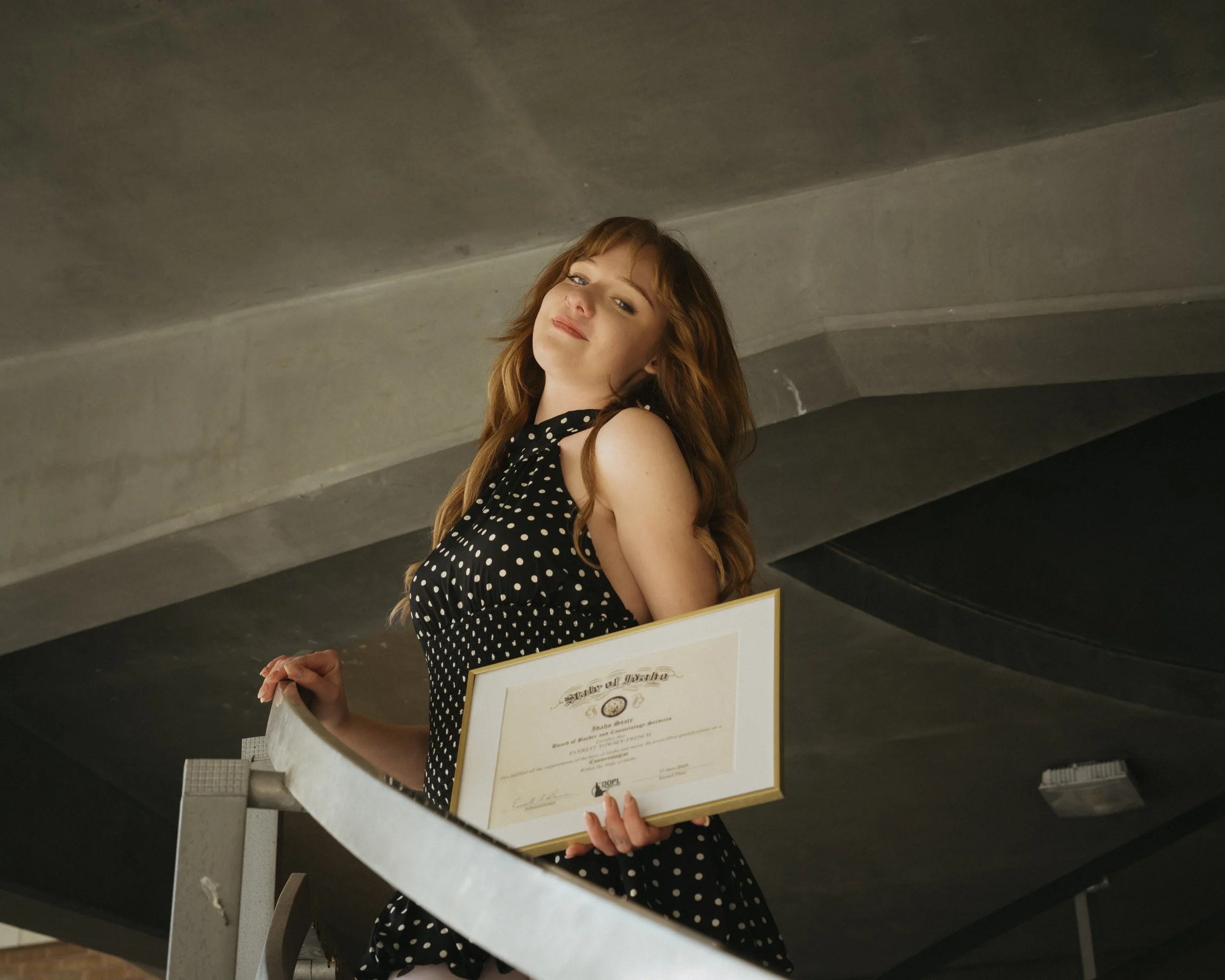 women graduating holding her diploma at idaho state university