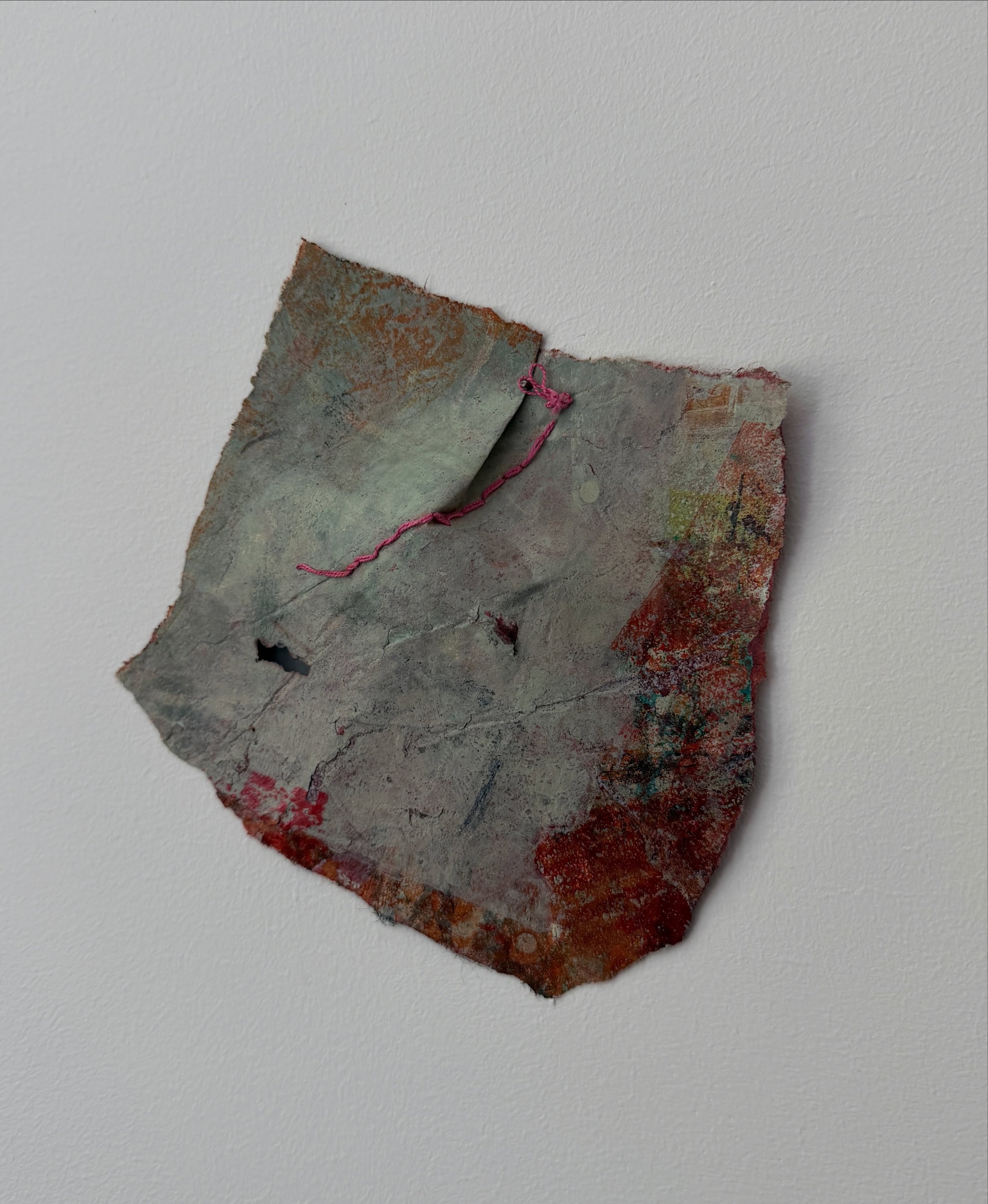 I&rsquo;ve been thinking about how little it takes to hold something together.

A torn fragment.
A few brads.
A strand of thread.

This piece left the studio this week and now lives directly on the wall, where its edges, shadows, and imperfections ca