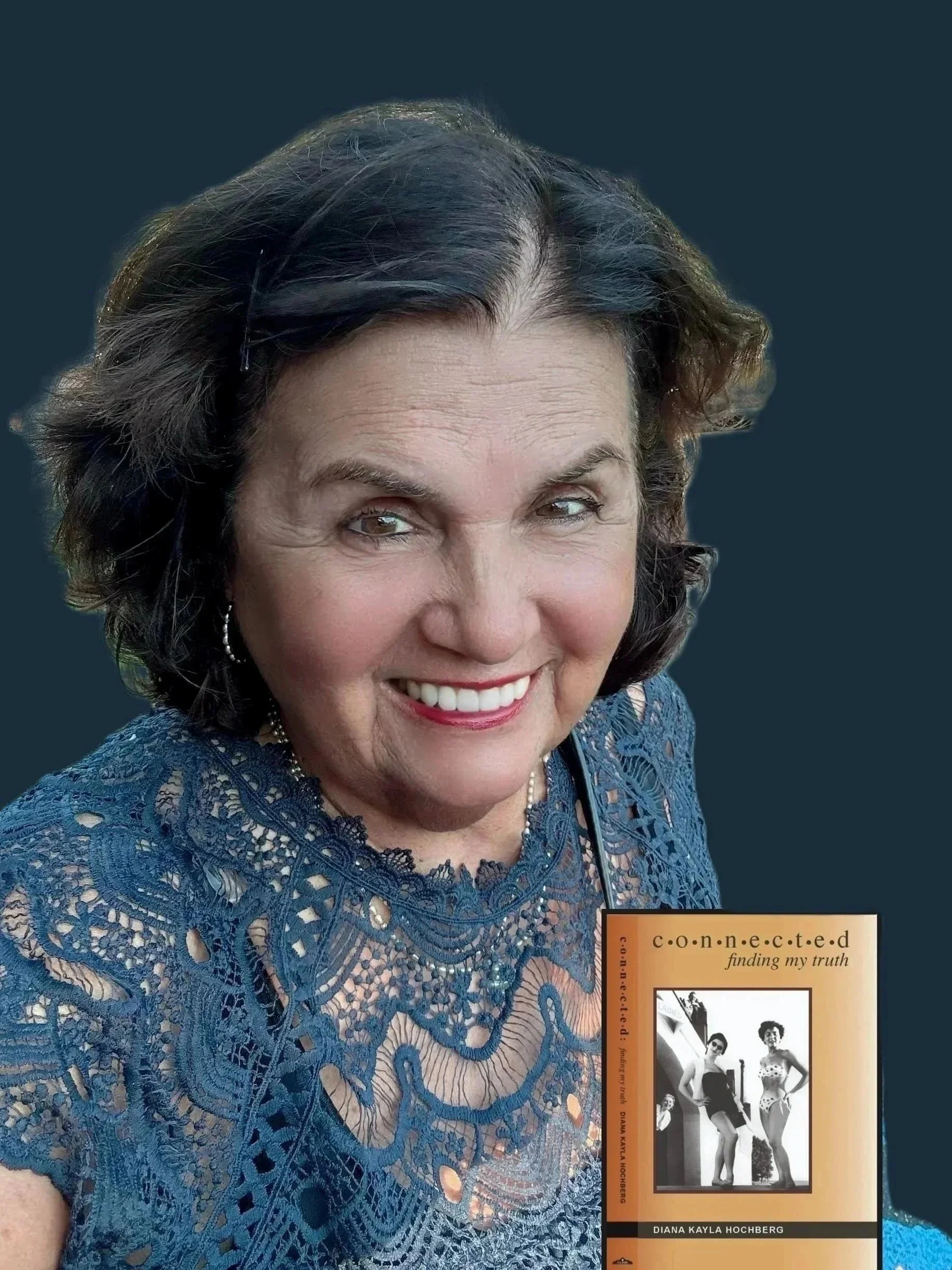 A woman with dark hair wearing a blue lace top, smiling, with a book titled 'Connected: finding my truth' by Diana Kayla Hochberg. The background is dark.