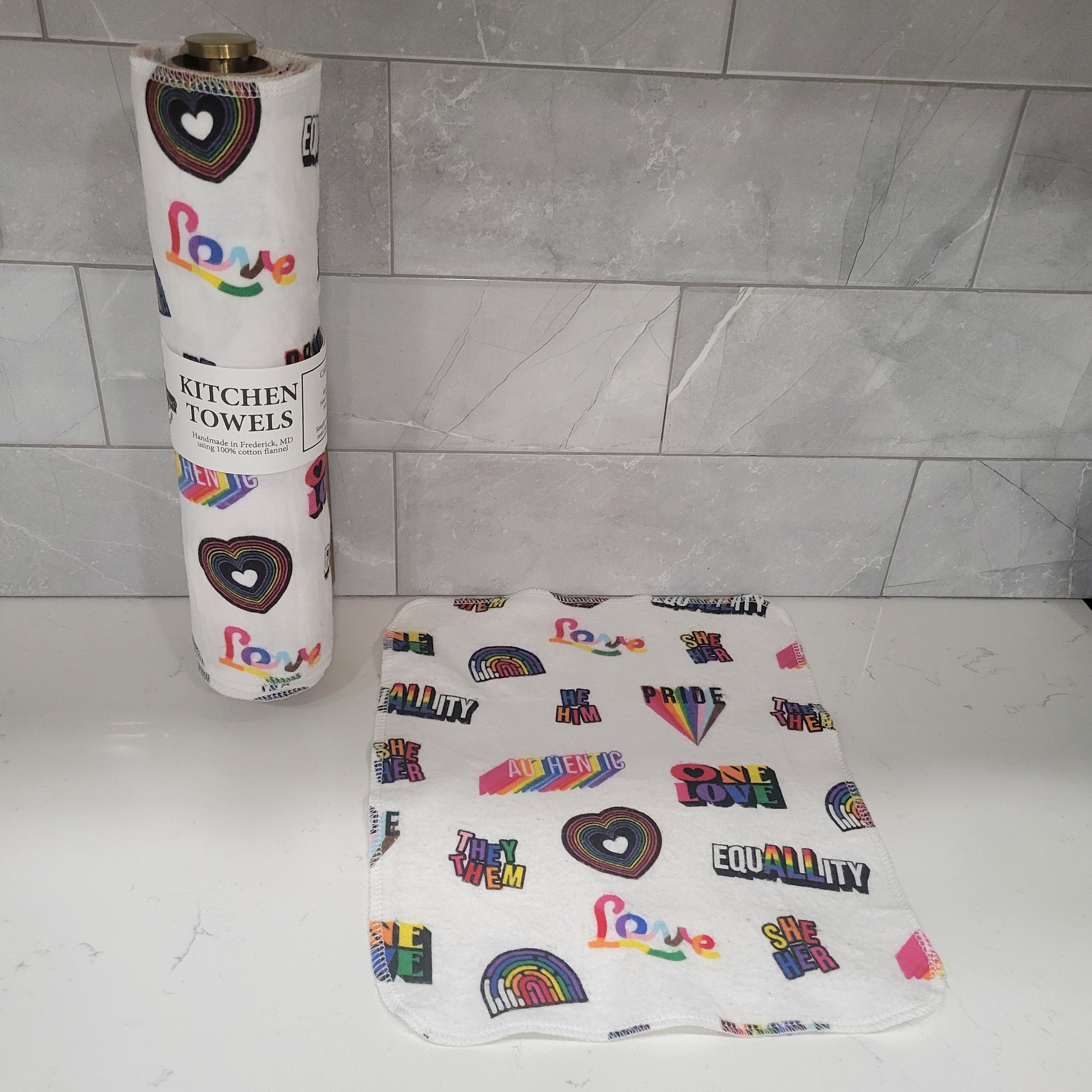 Kitchen Towels on a Roll with Pride print plus a single towel laying flat
