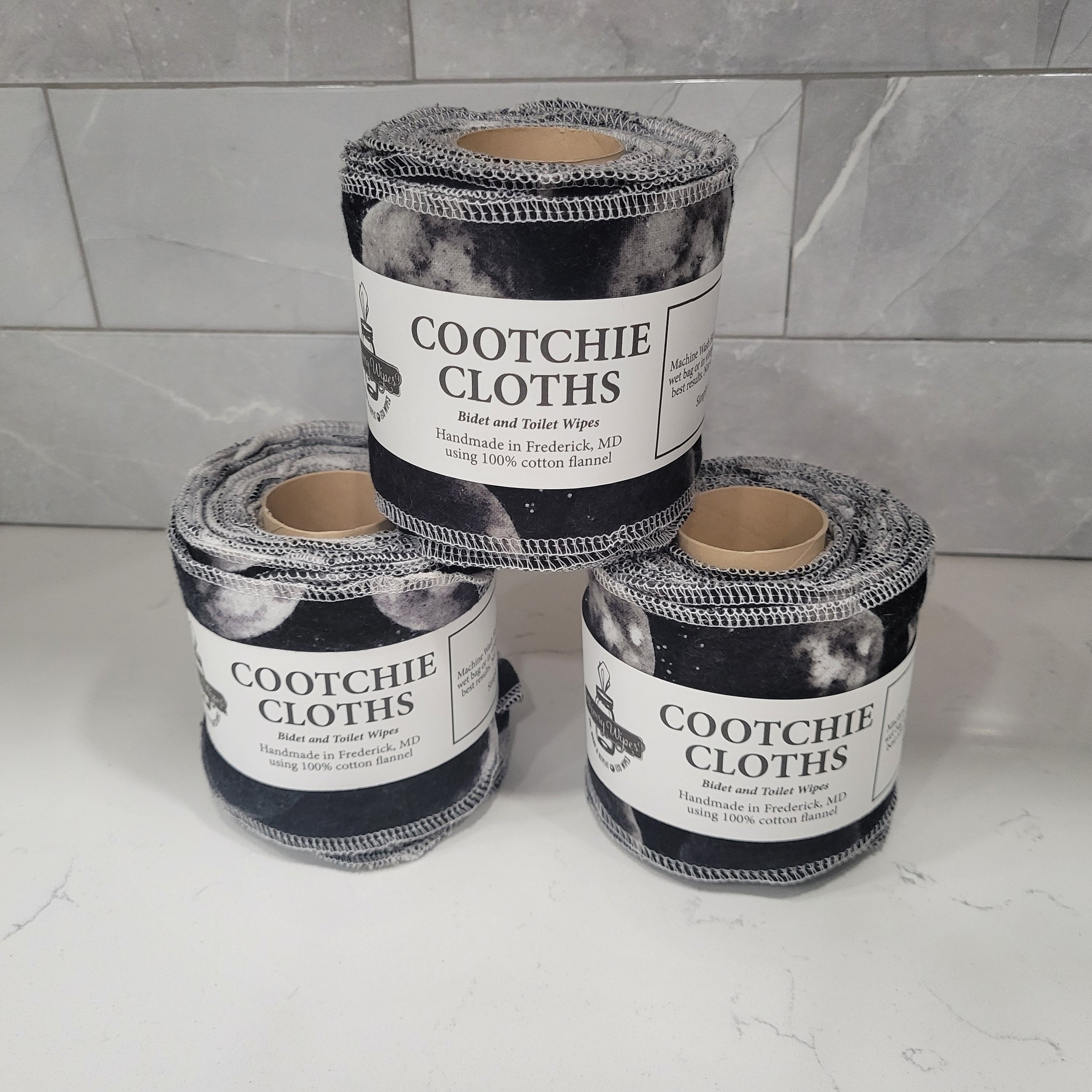 Three rolls of reusable toilet paper. Each strip is displaying the phases of the moon on a black background