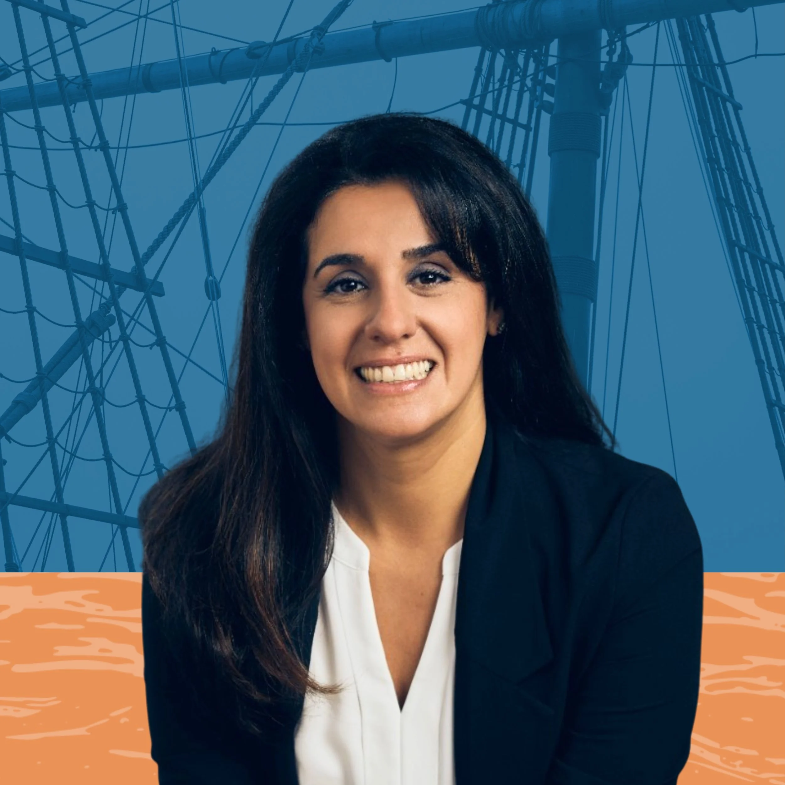 A woman with dark brown hair smiling at the camera, dressed in a black blazer and white blouse, with a background of a ship's rigging and a body of water.