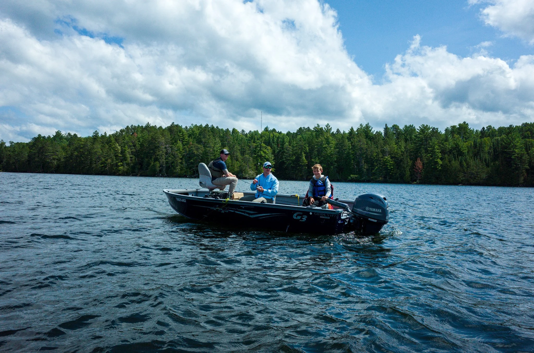 Cameron learning to drive the boat