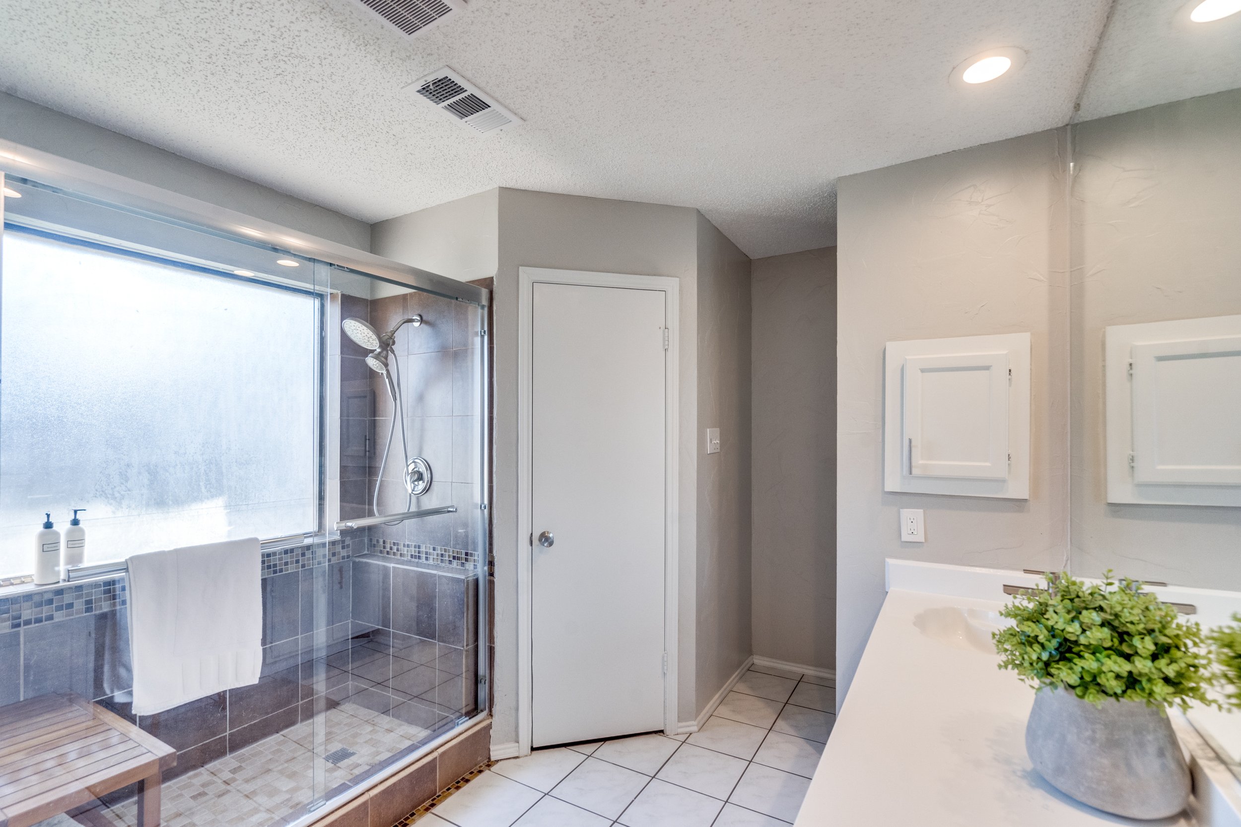 En Suite Primary Bathroom with His and Her Closets