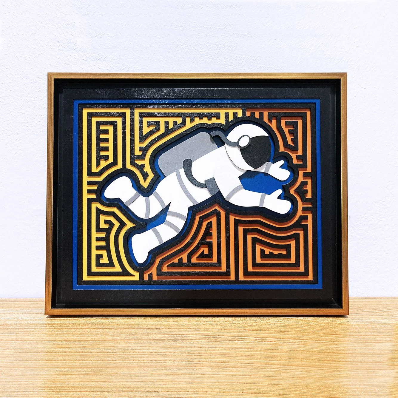 Wood layered art with gold frame.