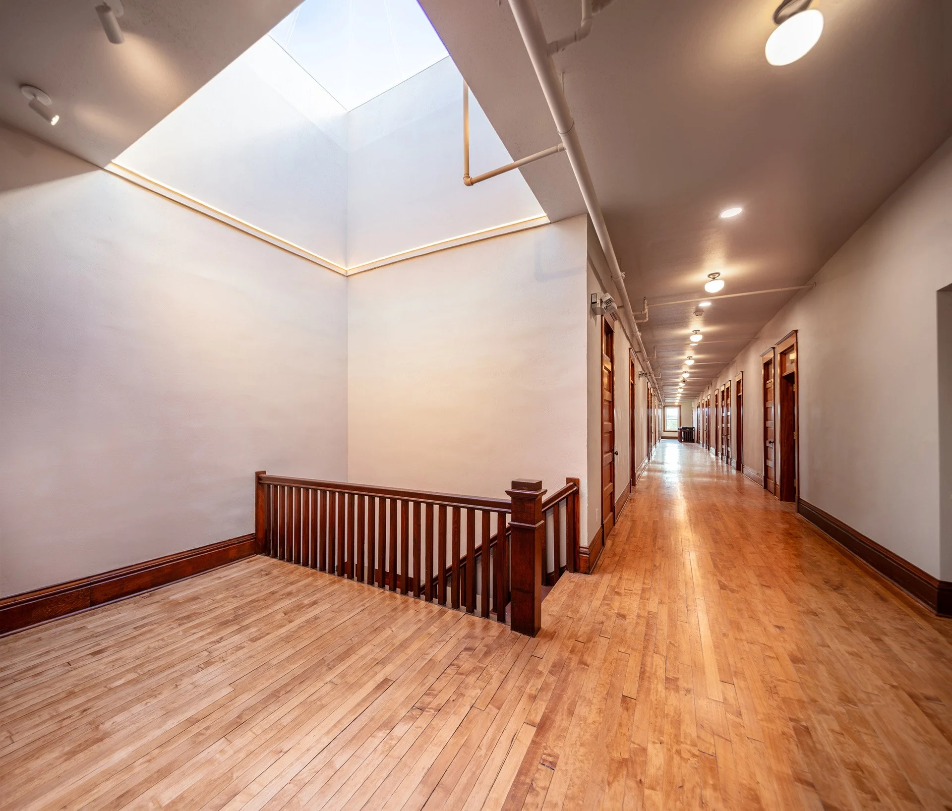 Hallway and light coming down from a skylight inside Baatz Block Apartments