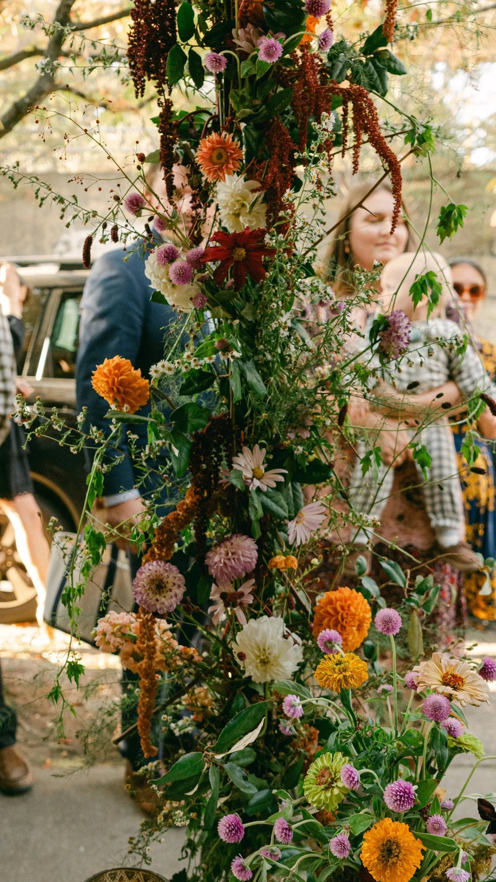 A garden inspired floral column in a fall palette at a wedding reception in Atlanta, Ga
