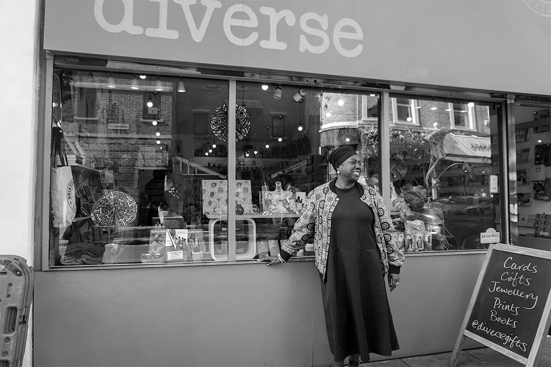 Owner of Diverse community shop standing outside her shop