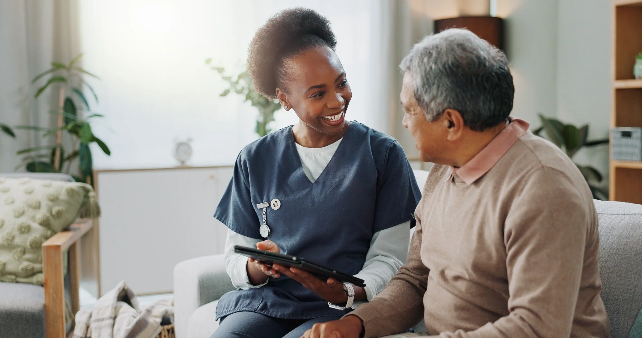 Home care professional providing compassionate in-home support to an older adult