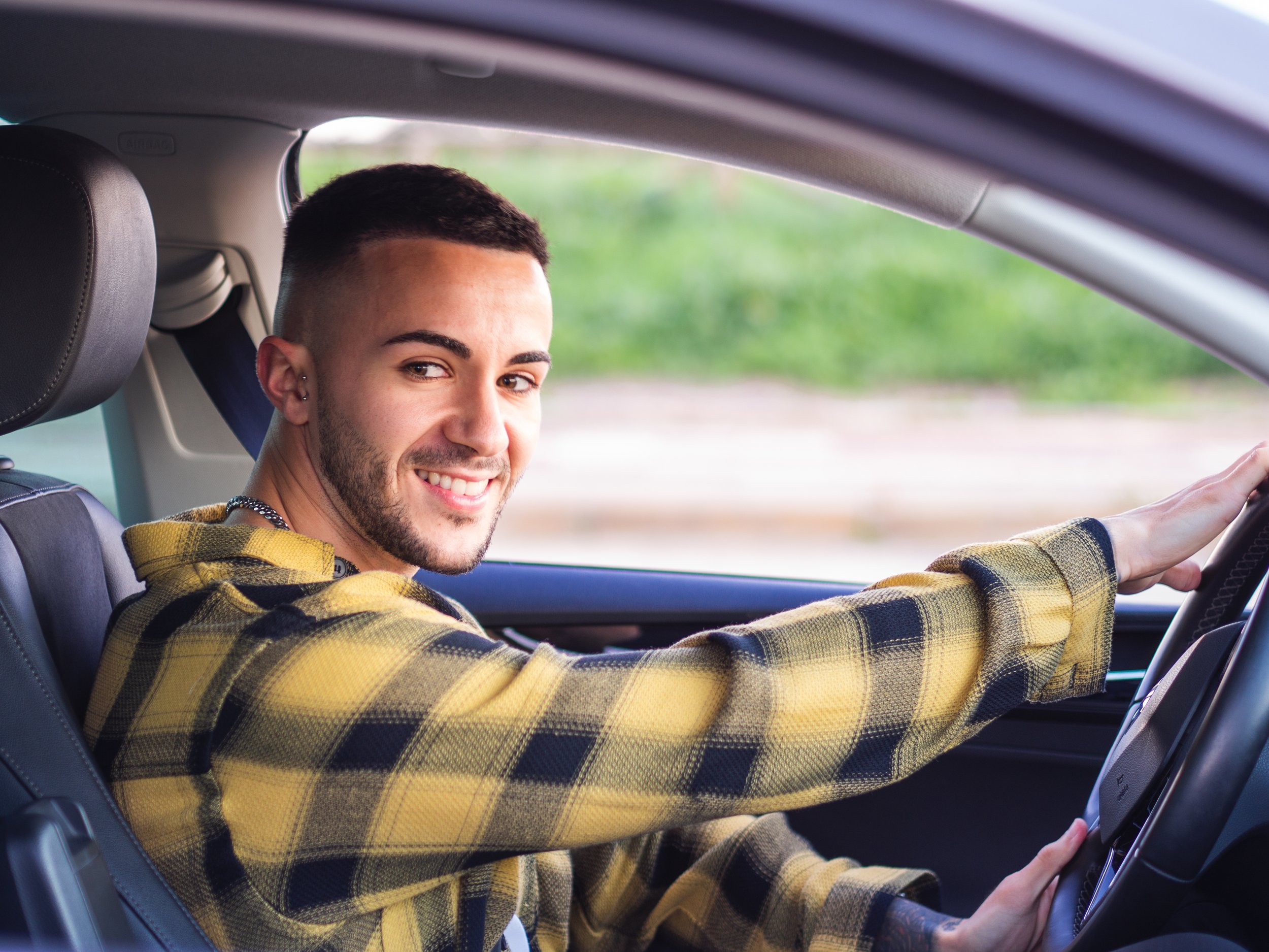 young-spanish-man-smiling-driving-car.jpg