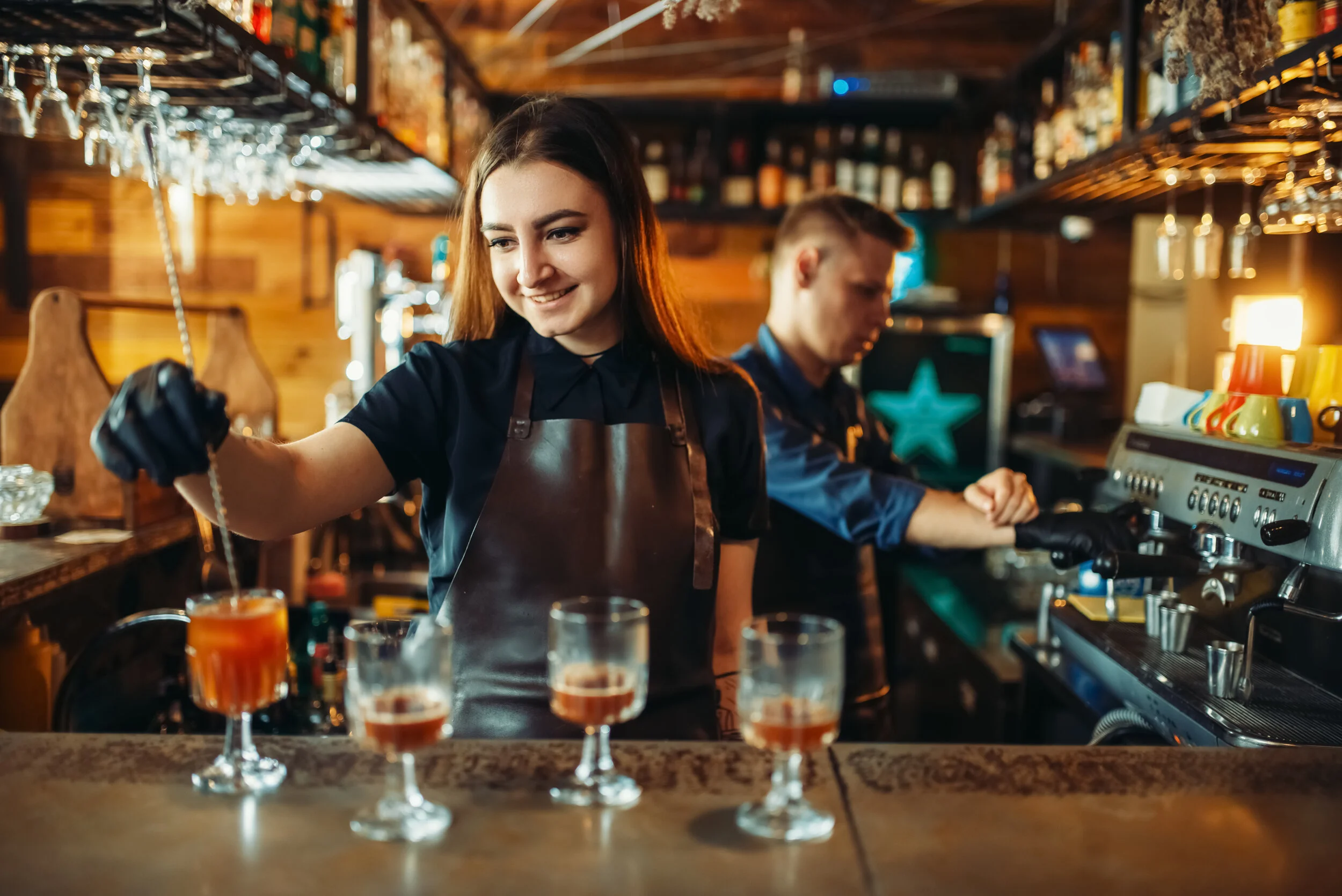 male-and-female-bartender-at-the-bar-counter-TZK6C9U.jpg