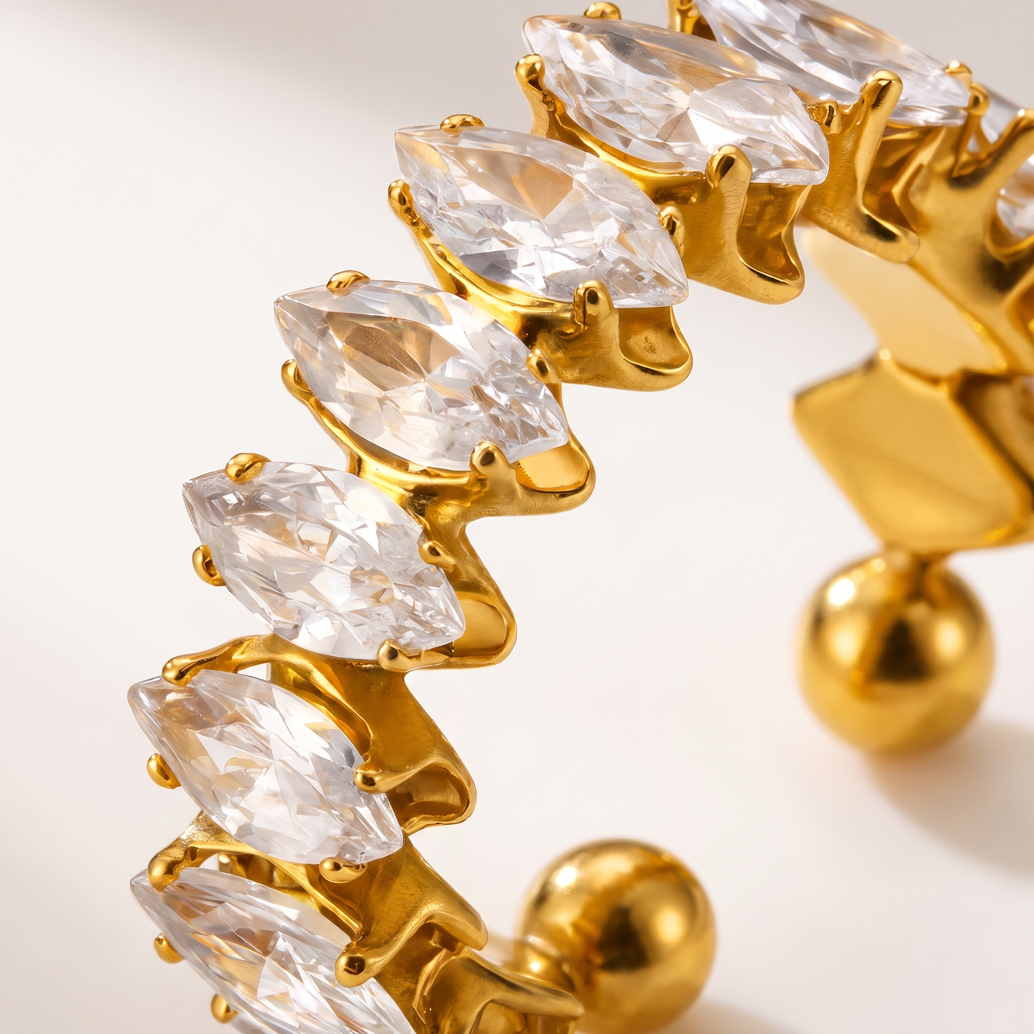 Close-up of gold adjustable ring with marquise cubic zirconia stones and PVD gold-plated finish